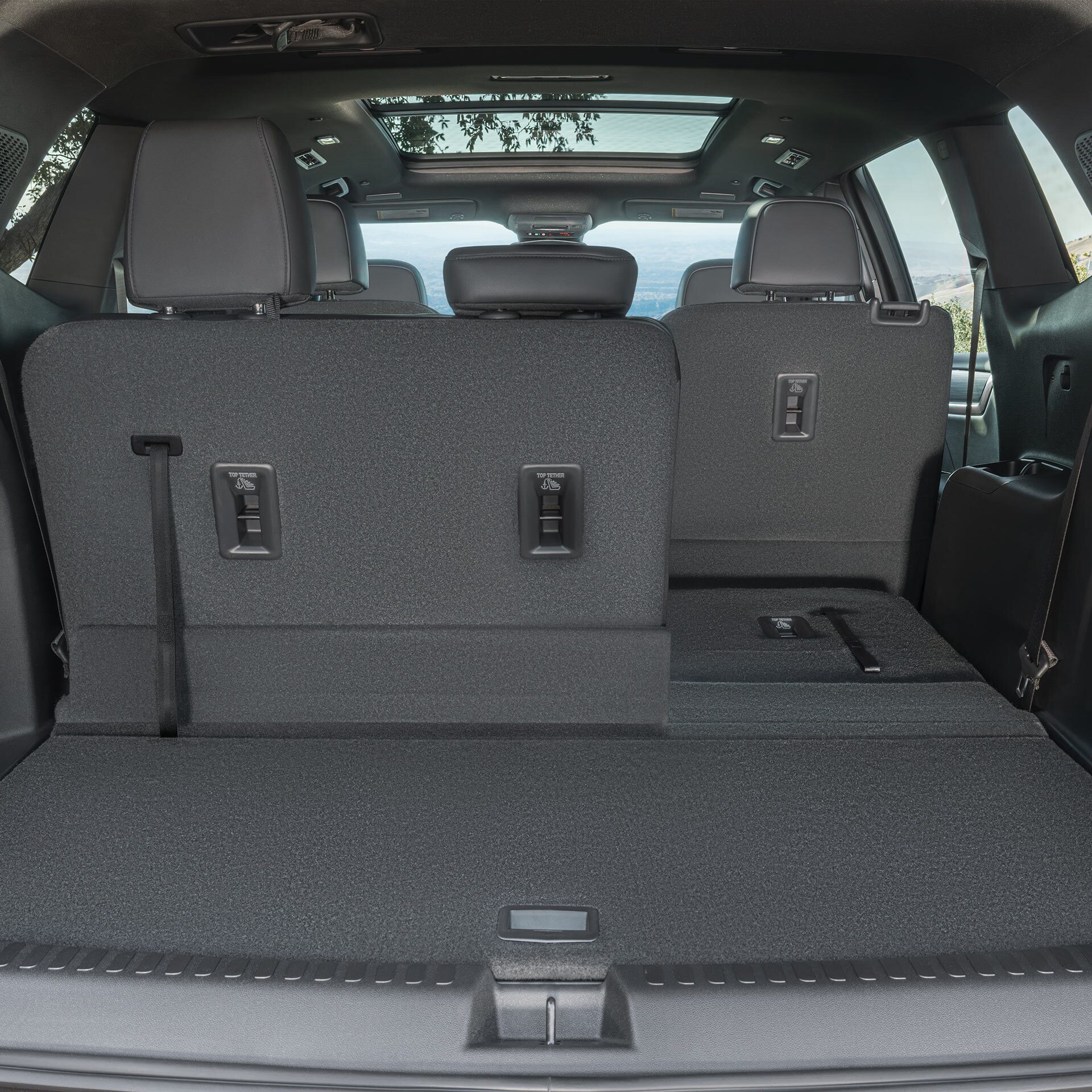 The Open Cargo Area of a Red GMC SUV, Showing The Spacious Rear With Folded-Down Seats