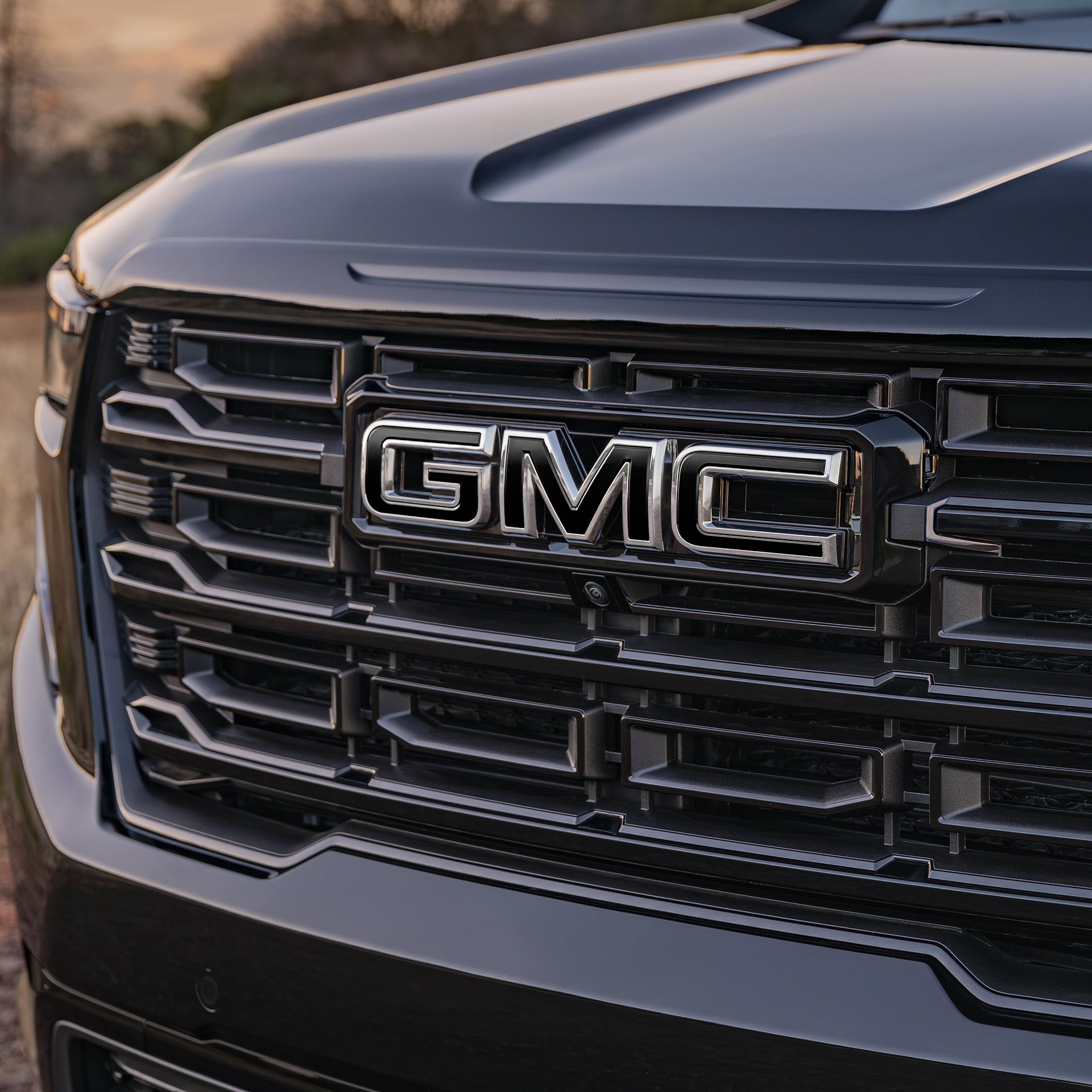 A Close-up of the Front Grille on a GMC Vehicle with a Chrome GMC Logo