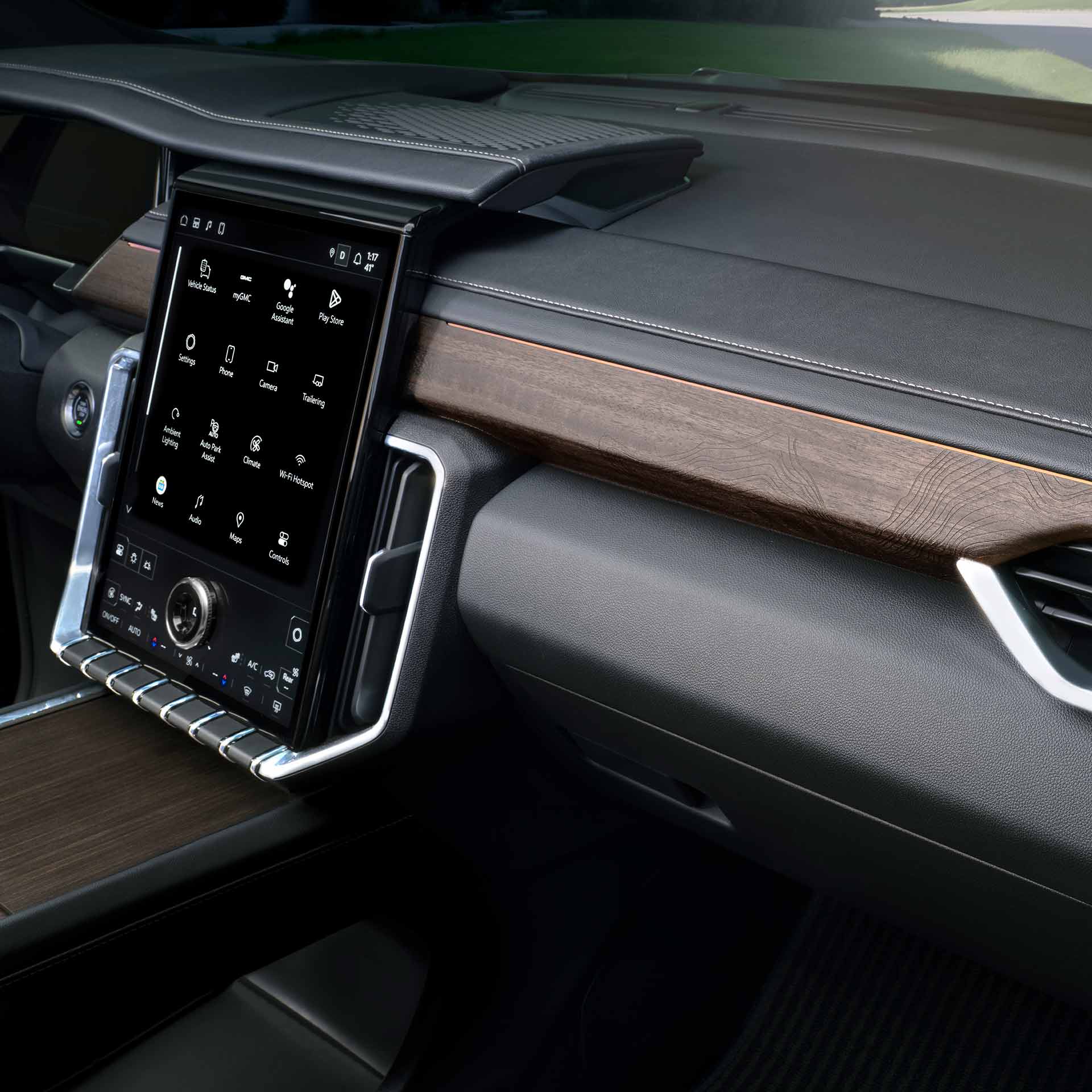 The Interior Dashboard of a GMC Vehicle with a Large Touchscreen Display and Wood Trim Accents