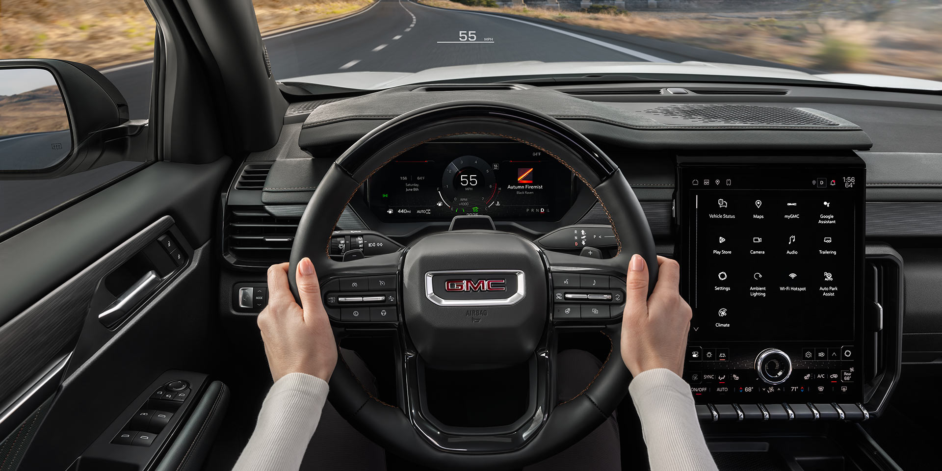 A Driver's Perspective Inside a GMC Vehicle, With Hands on The Steering Wheel, Showing The Digital Instrument Cluster and Road Ahead