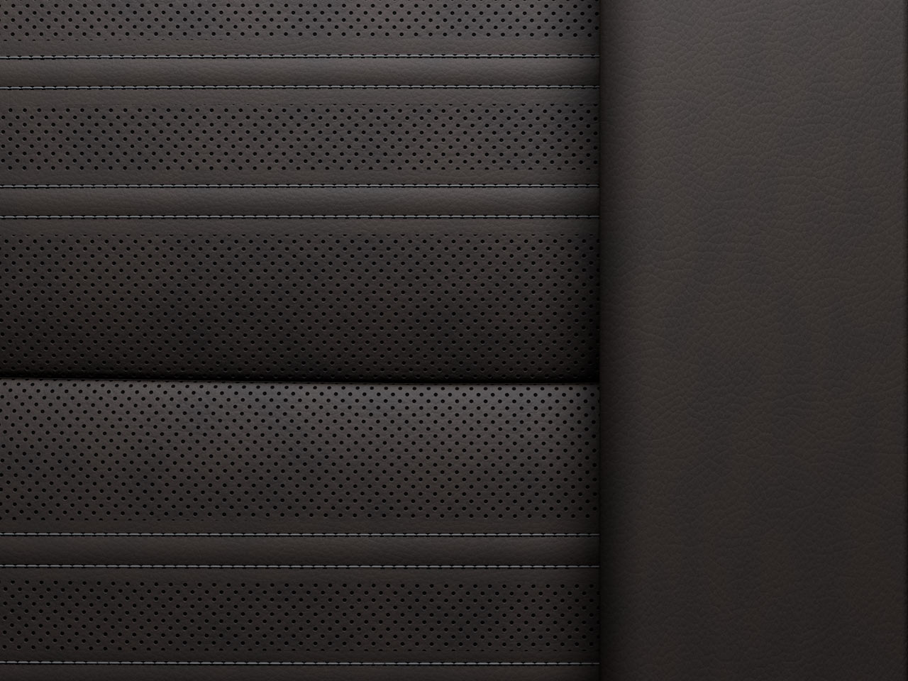 A Close-up View of Dark Gray Perforated Leather Seating with Horizontal Stitching