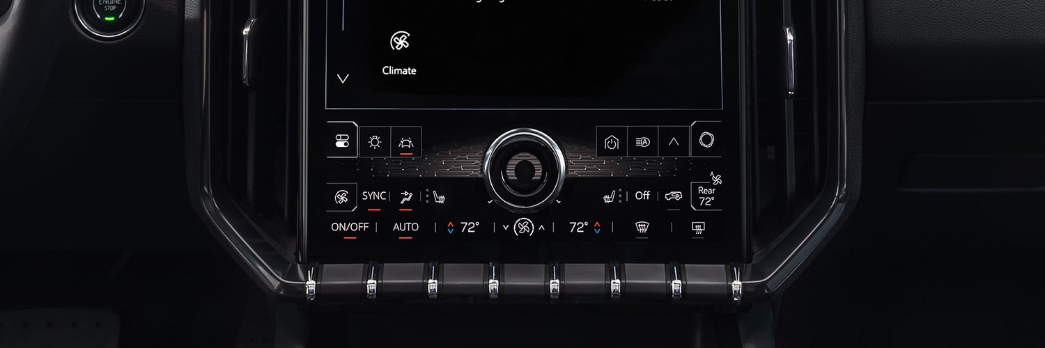 An Interior View of a GMC Vehicle's Climate Control System on a Digital Touchscreen Display With Physical Buttons Below