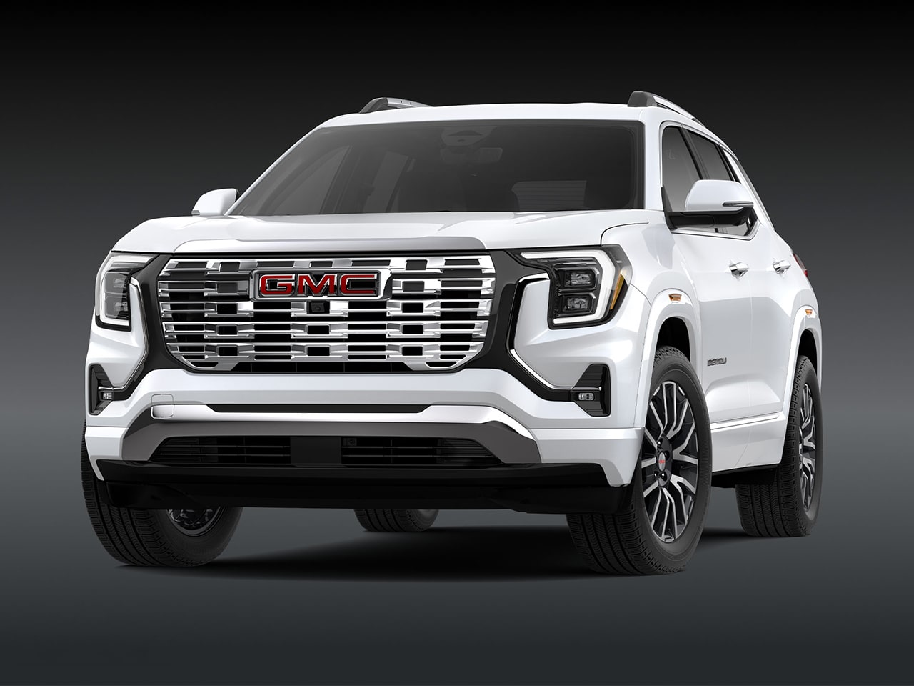 A Front Three-Quarter View of the White 2026 GMC Denali SUV on a Dark Background