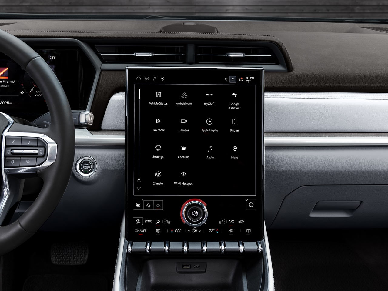 The Wide Interior View of the GMC Denali Dashboard Showing the Steering Wheel and Large Infotainment Screen