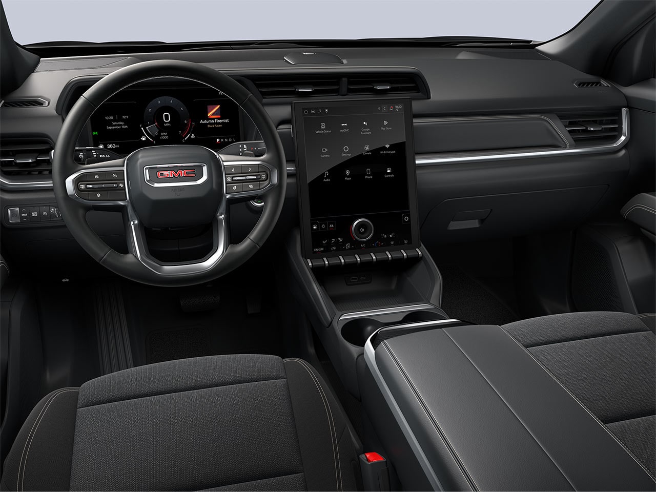 The Driver's View of a GMC Vehicle Dashboard with a Digital Screen and Dark Gray Cloth Seats
