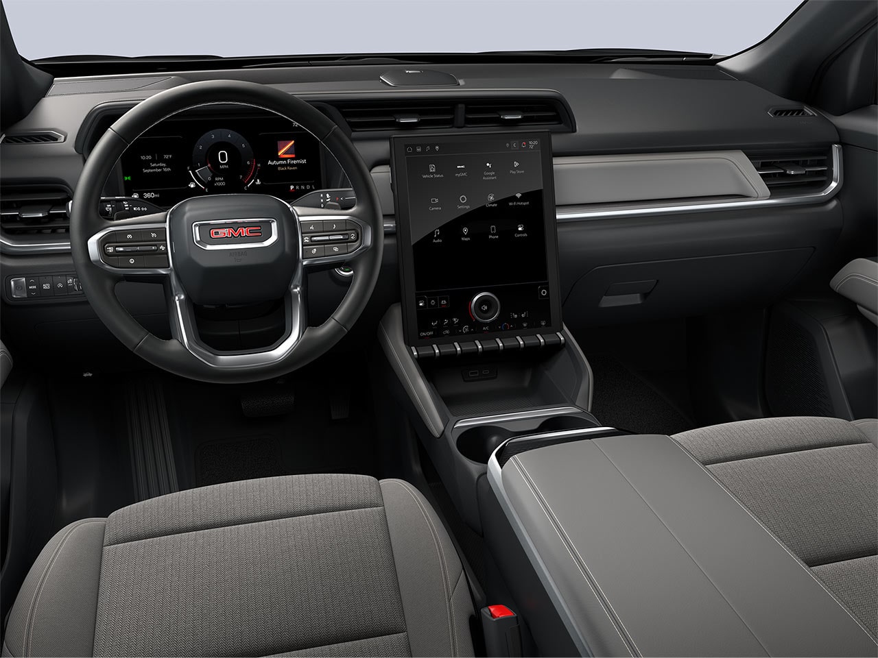 The Driver's View of a GMC Vehicle Dashboard with a Digital Screen and Dark Gray Cloth Seats
