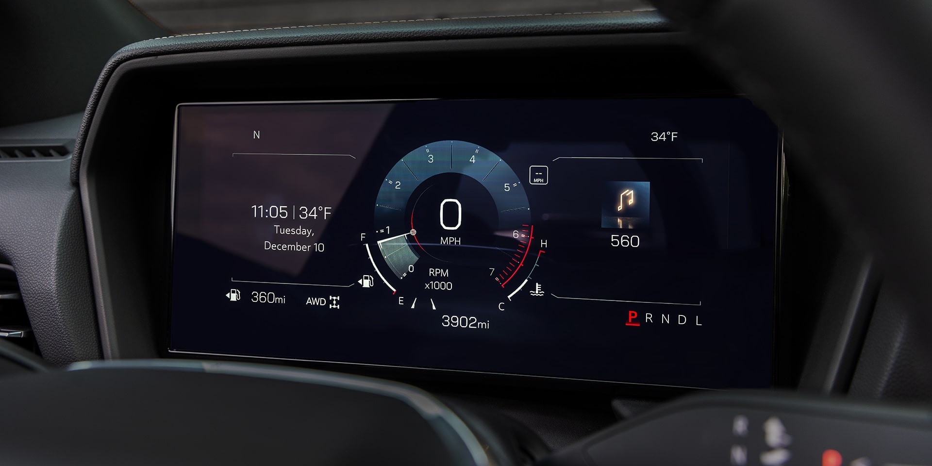 A Close-up Of a GMC Vehicle's Digital Instrument Cluster Behind the Steering Wheel Displaying Speed, Time, Temperature, Mileage, and Gear
