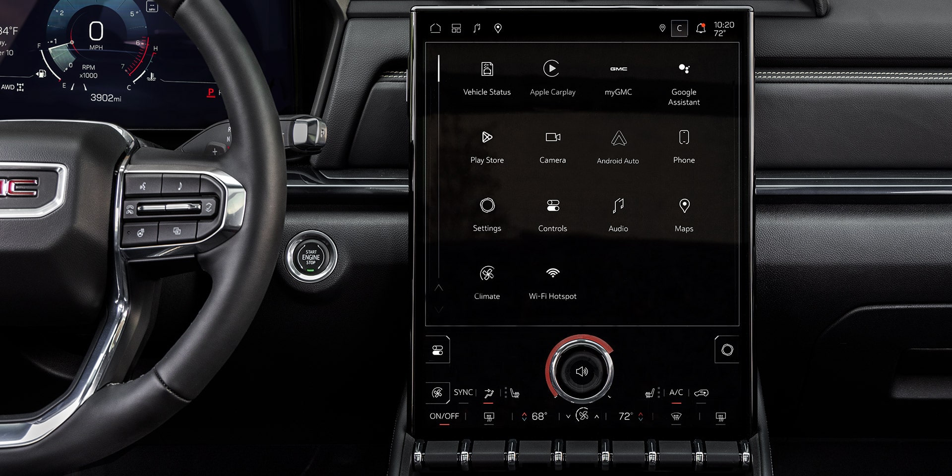 The Interior Of a GMC Vehicle Showing a Multi-function Steering Wheel With the GMC Logo and a Large Vertical Infotainment Screen