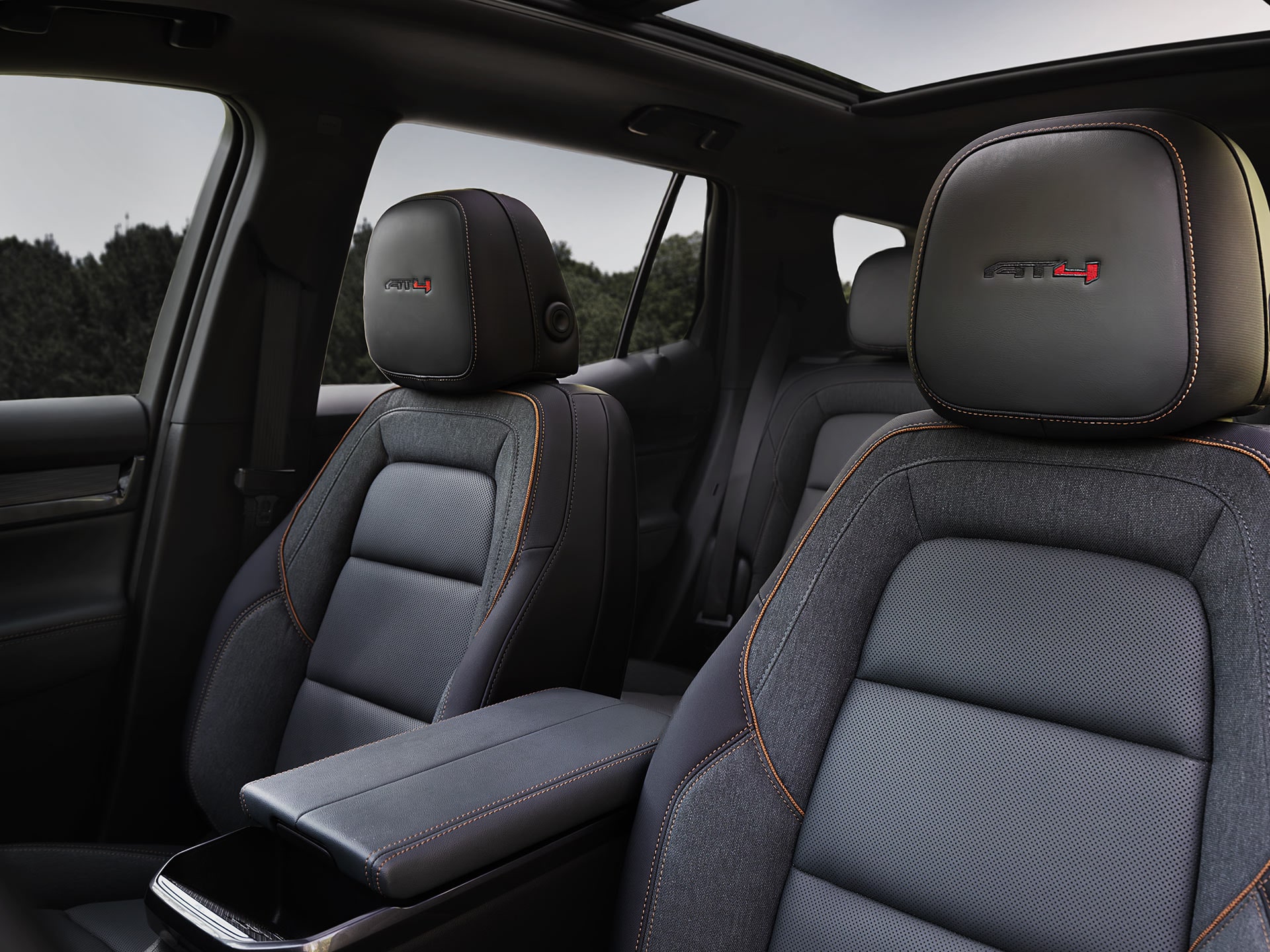 GMC Interior Featuring Dark Gray AT4 Front Seats with Orange Stitching and a Panoramic Sunroof