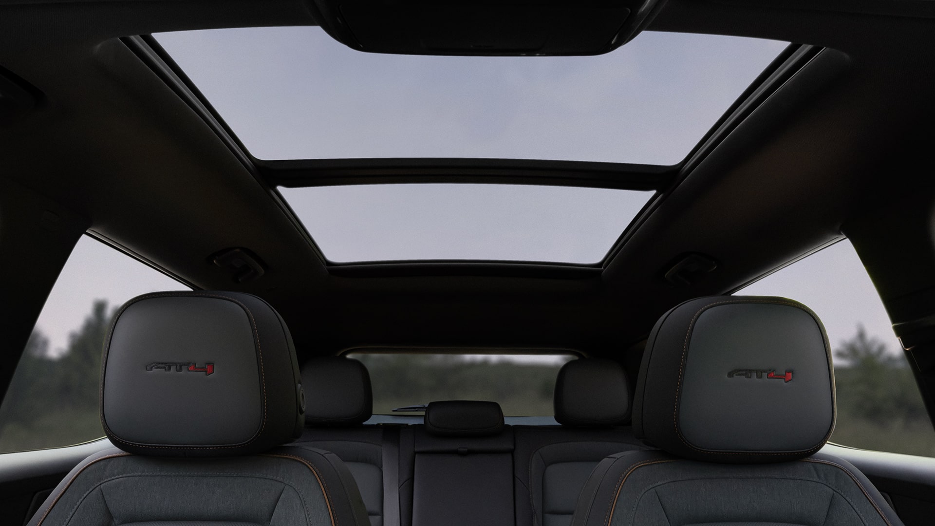 Interior View of a GMC Car Featuring Dark Gray AT4 Seats and a Panoramic Sunroof