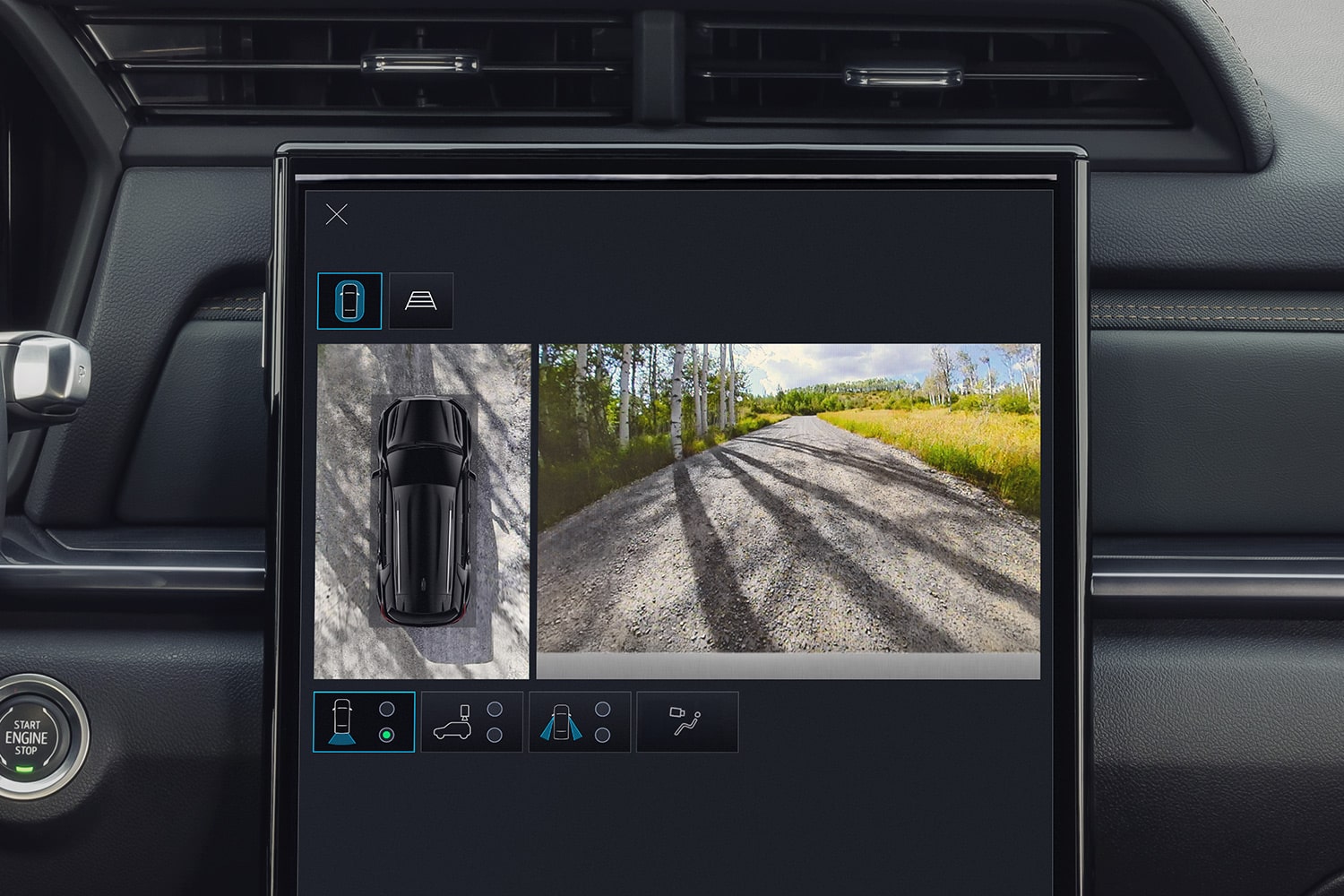 GMC Infotainment Screen Showing a 360-Degree Camera View of the SUV and a Gravel Road Ahead