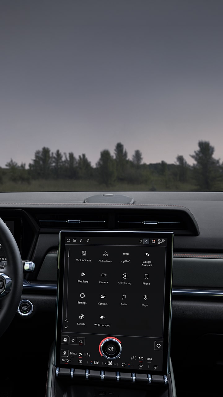 GMC Steering Wheel and Digital Instrument Cluster Alongside the Infotainment Screen Displaying Various Applications