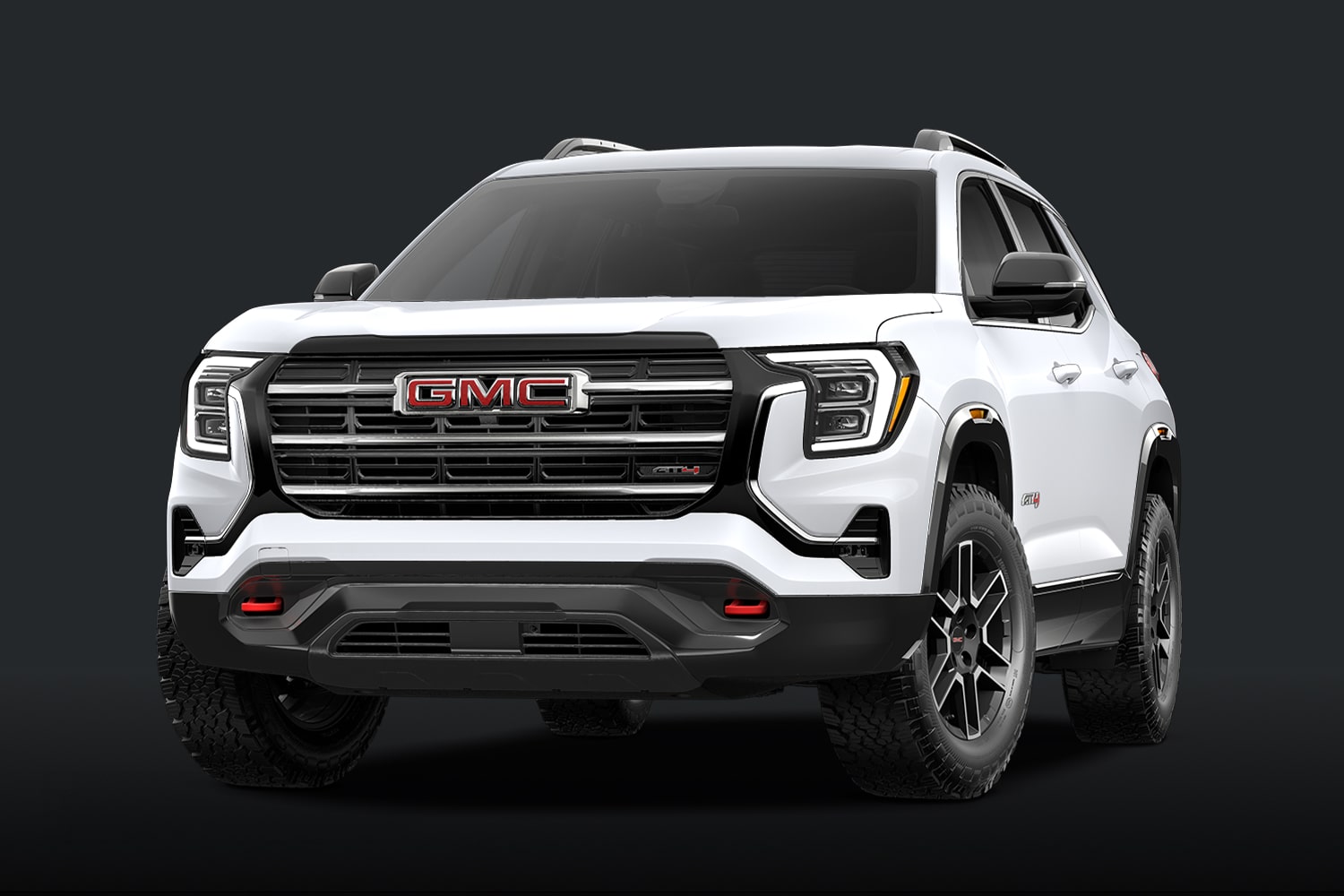 A White GMC AT4 SUV With a Dark Grille and Red Accents Against a Dark Background