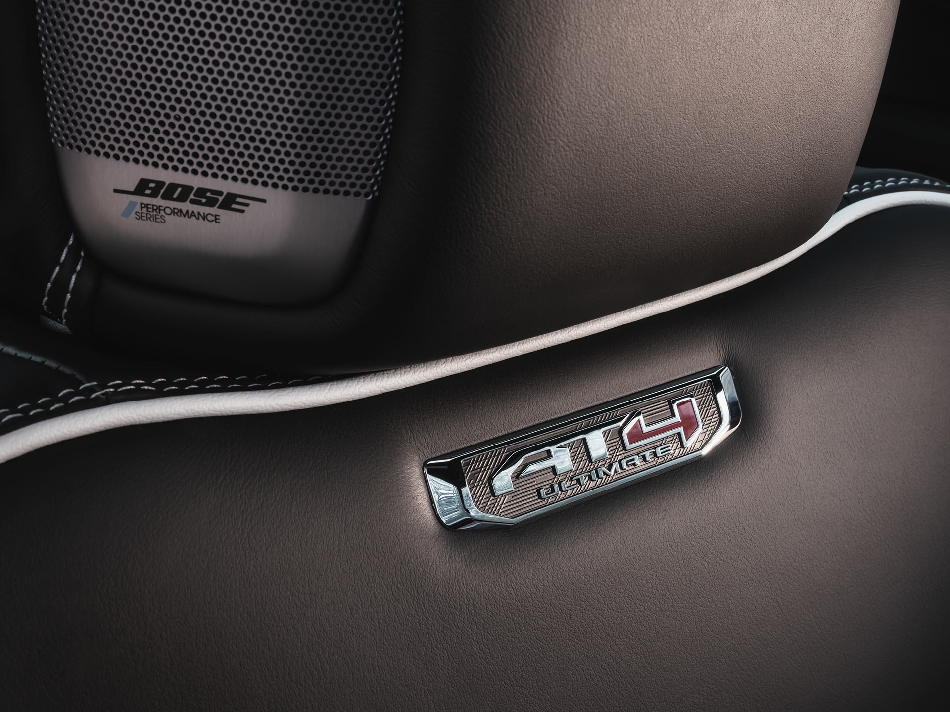 Close-up of the Rear Passenger Seat in the 2027 GMC Yukon Featuring an AT4X Badge and a Bose Speaker