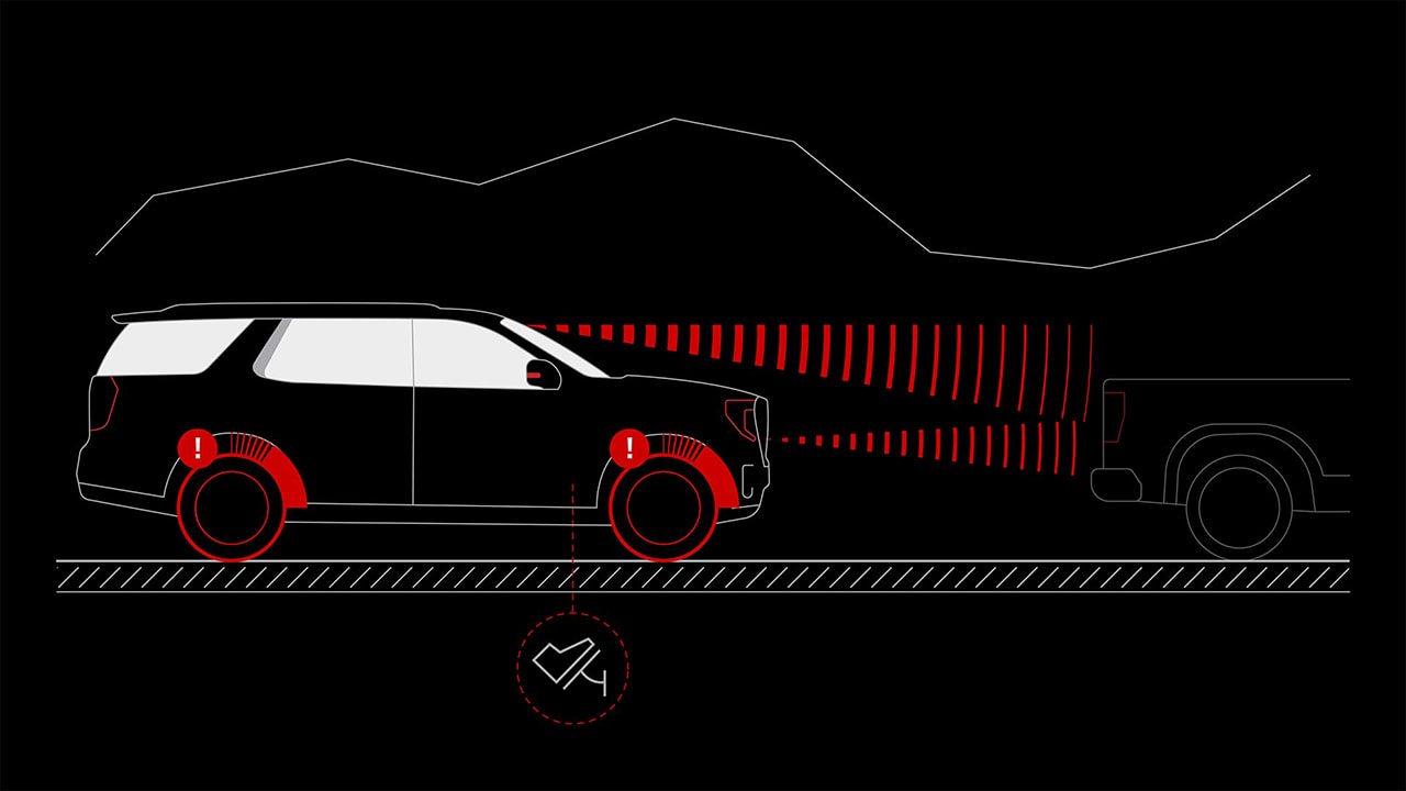 A Diagram of a Dark GMC Yukon Demonstrating Enhanced Automatic Emergency Braking While Approaching a Truck