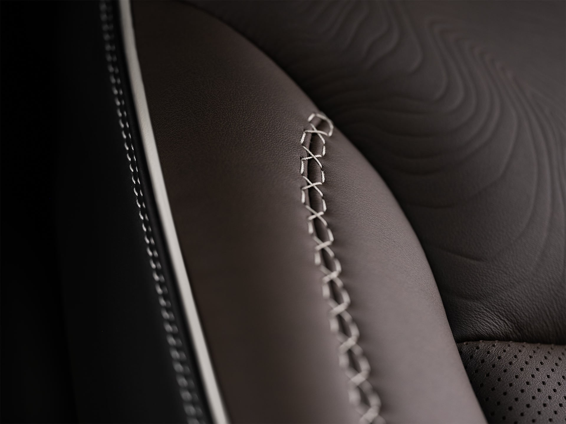 Close-Up Detail of the Decorative Stitching on a Brown Leather Seat in a 2027 GMC Yukon Denali Ultimate