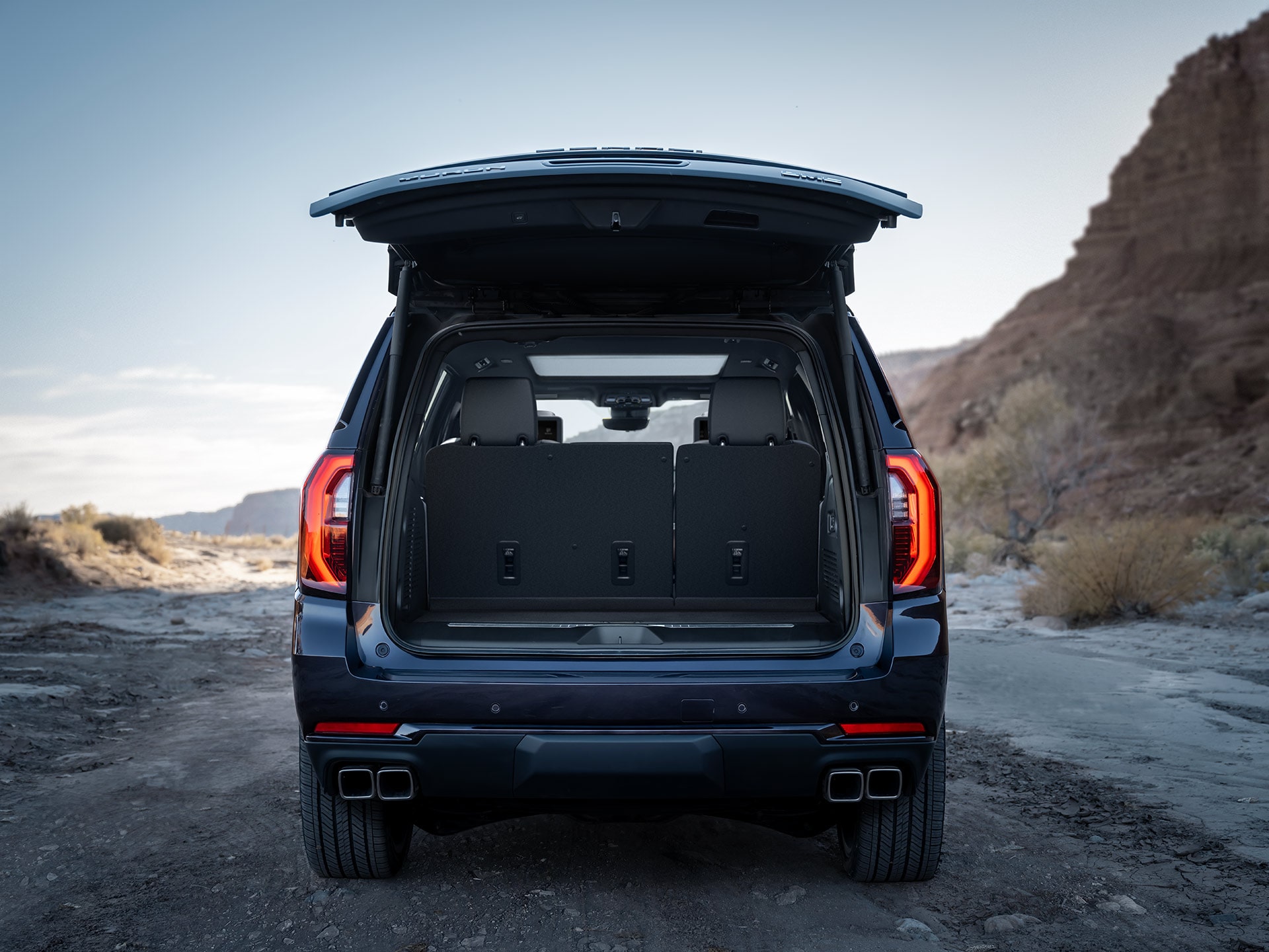 A Dark Blue GMC Yukon with its Tailgate Open Revealing the Cargo Area