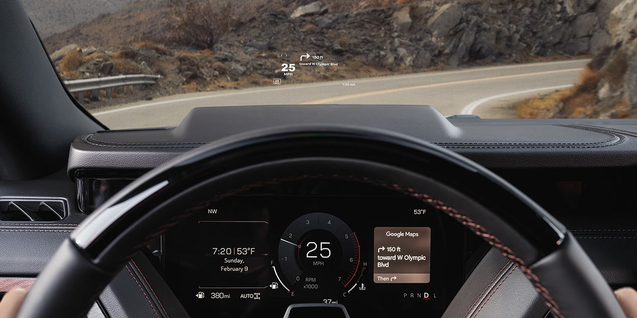 Driver's View Showing a Head-Up Display with Navigation Instructions over a Mountain Road