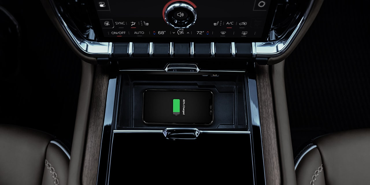 A Smartphone Wirelessly Charging in the Center Console of a GMC Yukon