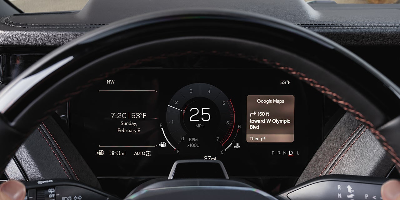 A Driver's View of the Digital Gauge Cluster and Steering Wheel with Google Maps Navigation in a GMC Yukon