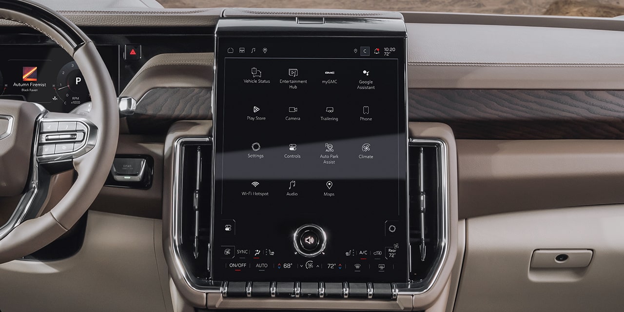 Front Interior Dashboard of a 2027 GMC Yukon Denali, Featuring the Large Vertical Infotainment Touchscreen and Steering Wheel