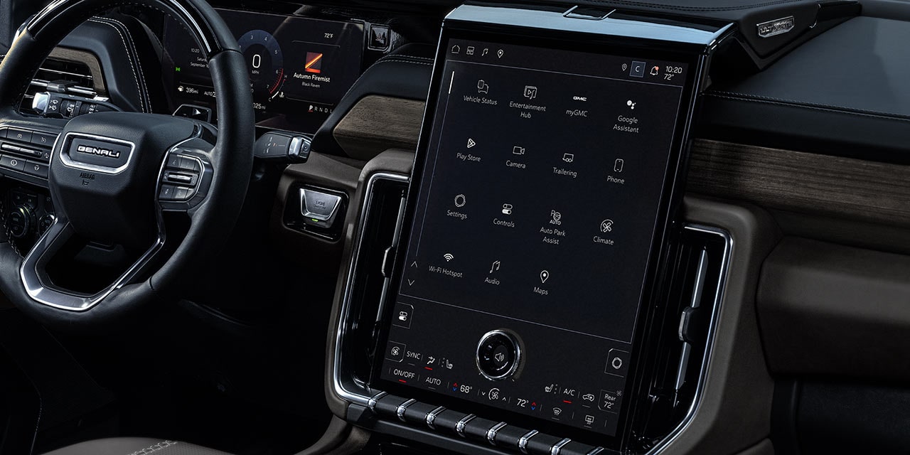 Interior View of the 2027 GMC Yukon Denali Dashboard with a Large Vertical Infotainment Screen Displaying Multiple App Icons