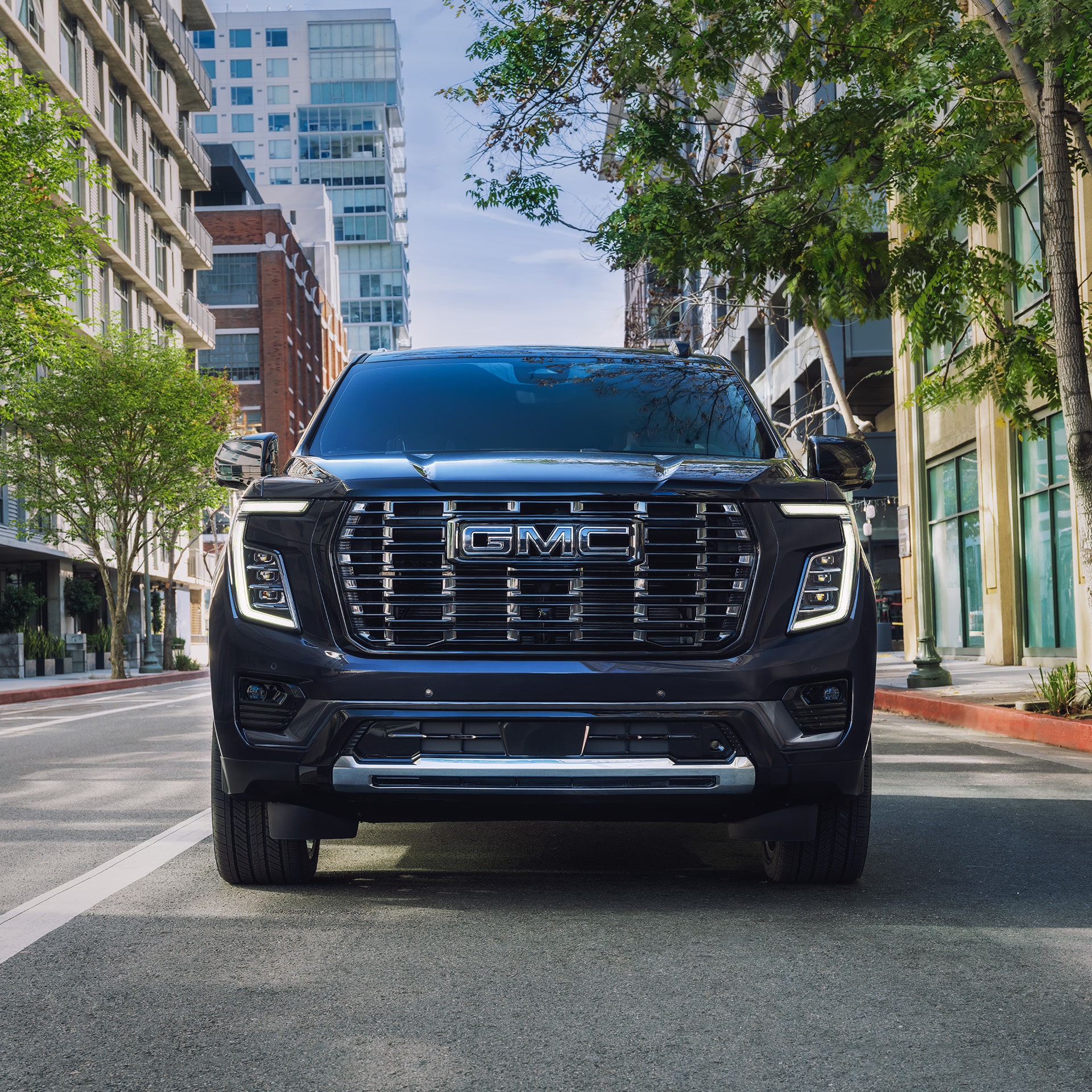 Front View of a Dark 2027 GMC Yukon Denali Parked on a City Street