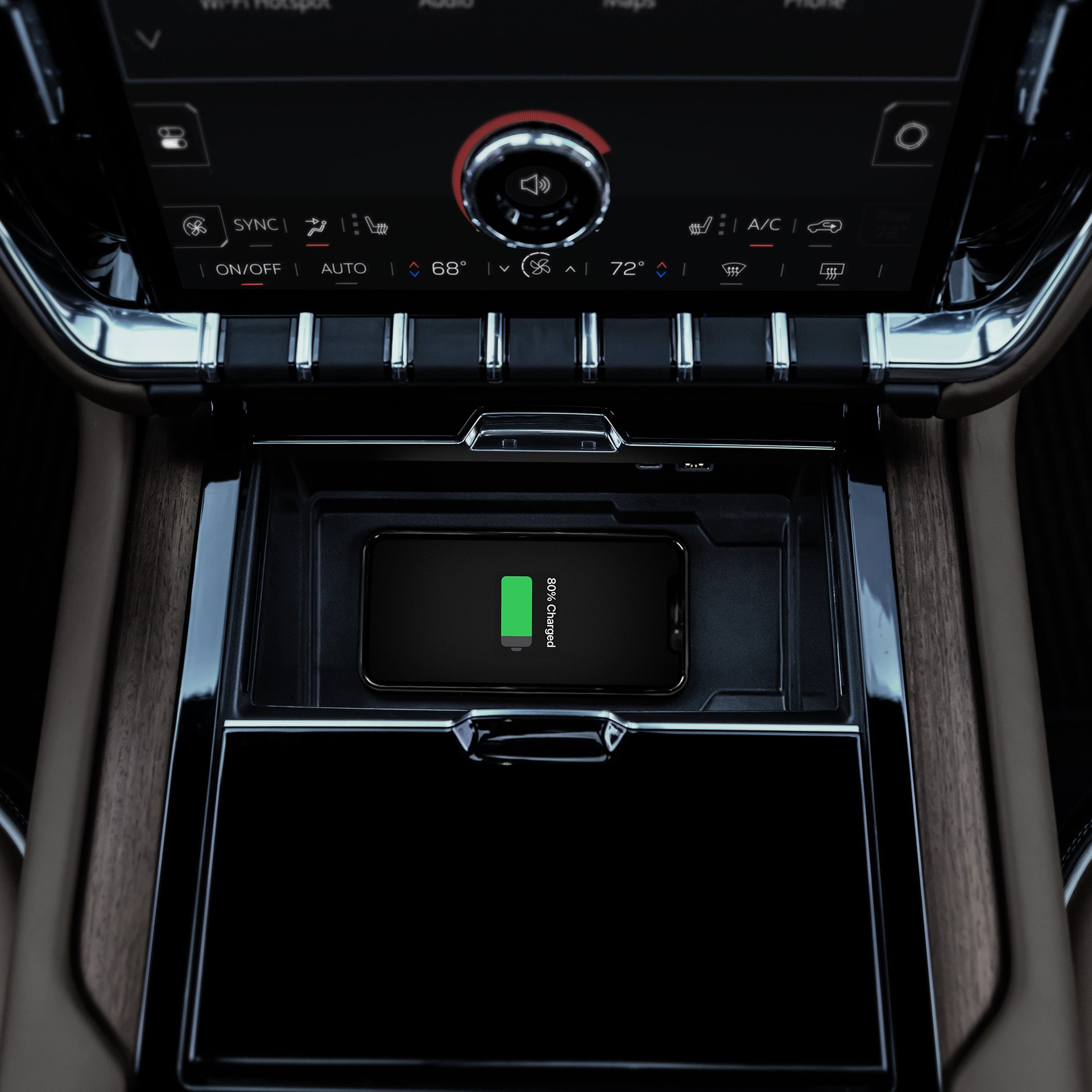 A Smartphone Wirelessly Charging in the Center Console of a GMC Yukon