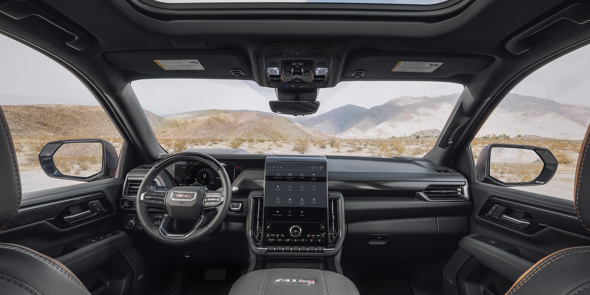 Interior Wide Shot of the Cockpit of a 2027 GMC Yukon with a Large Infotainment Screen