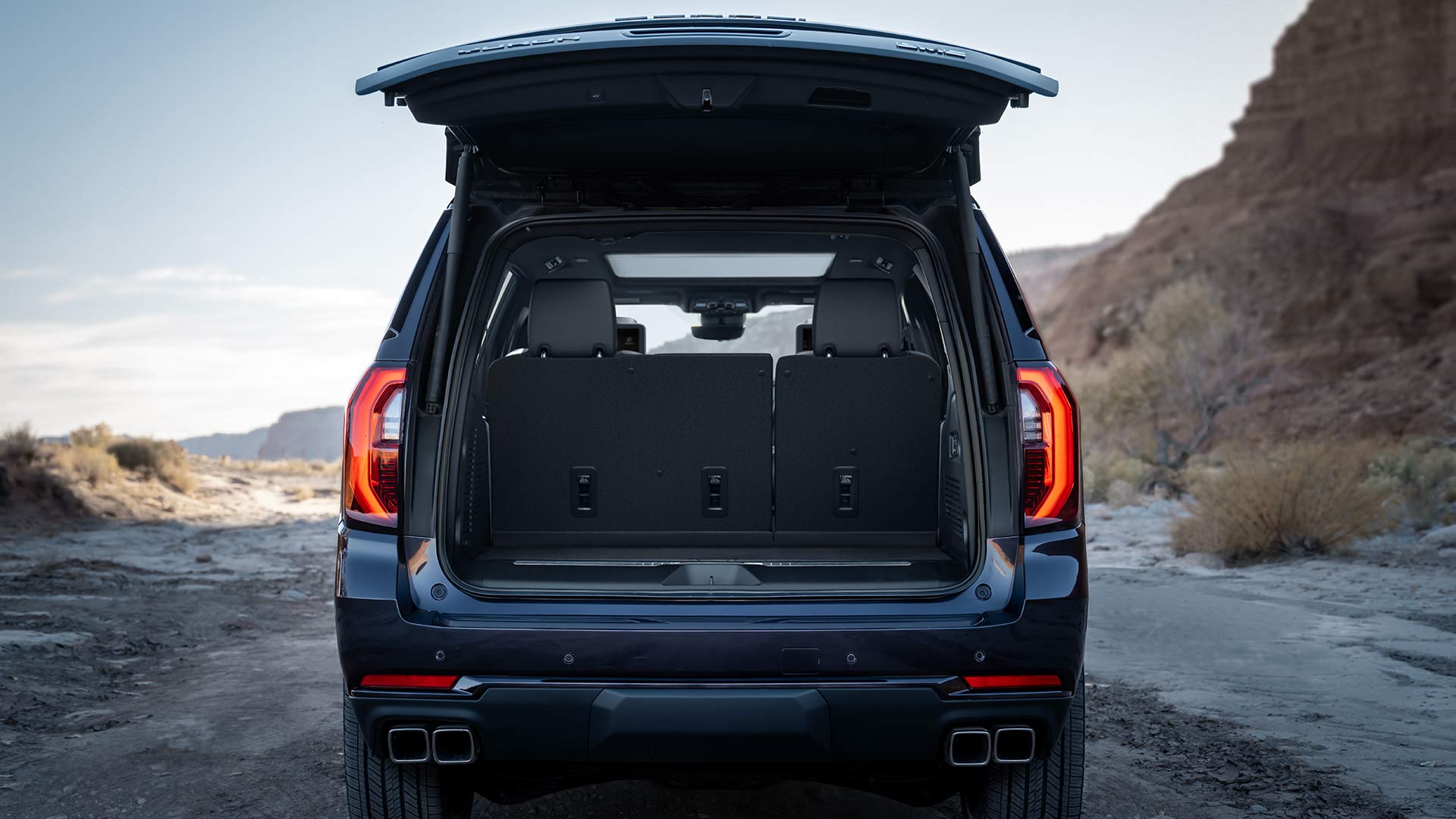 A Dark Blue GMC Yukon with its Tailgate Open Revealing the Cargo Area