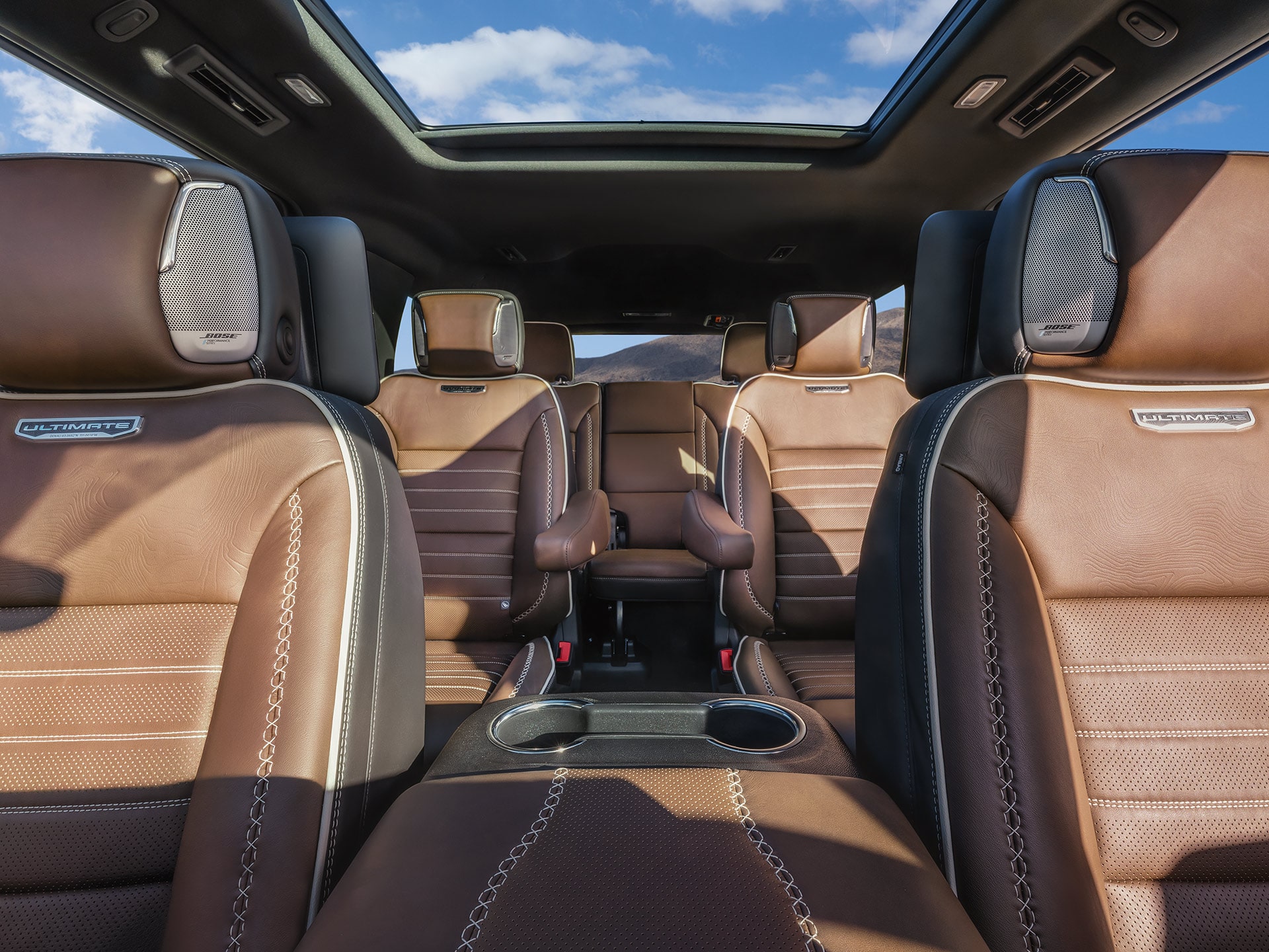 Close-Up of a GMC Yukon Denali Ultimate Brown Leather Seat Headrest with Integrated Bose Performance Series Speaker