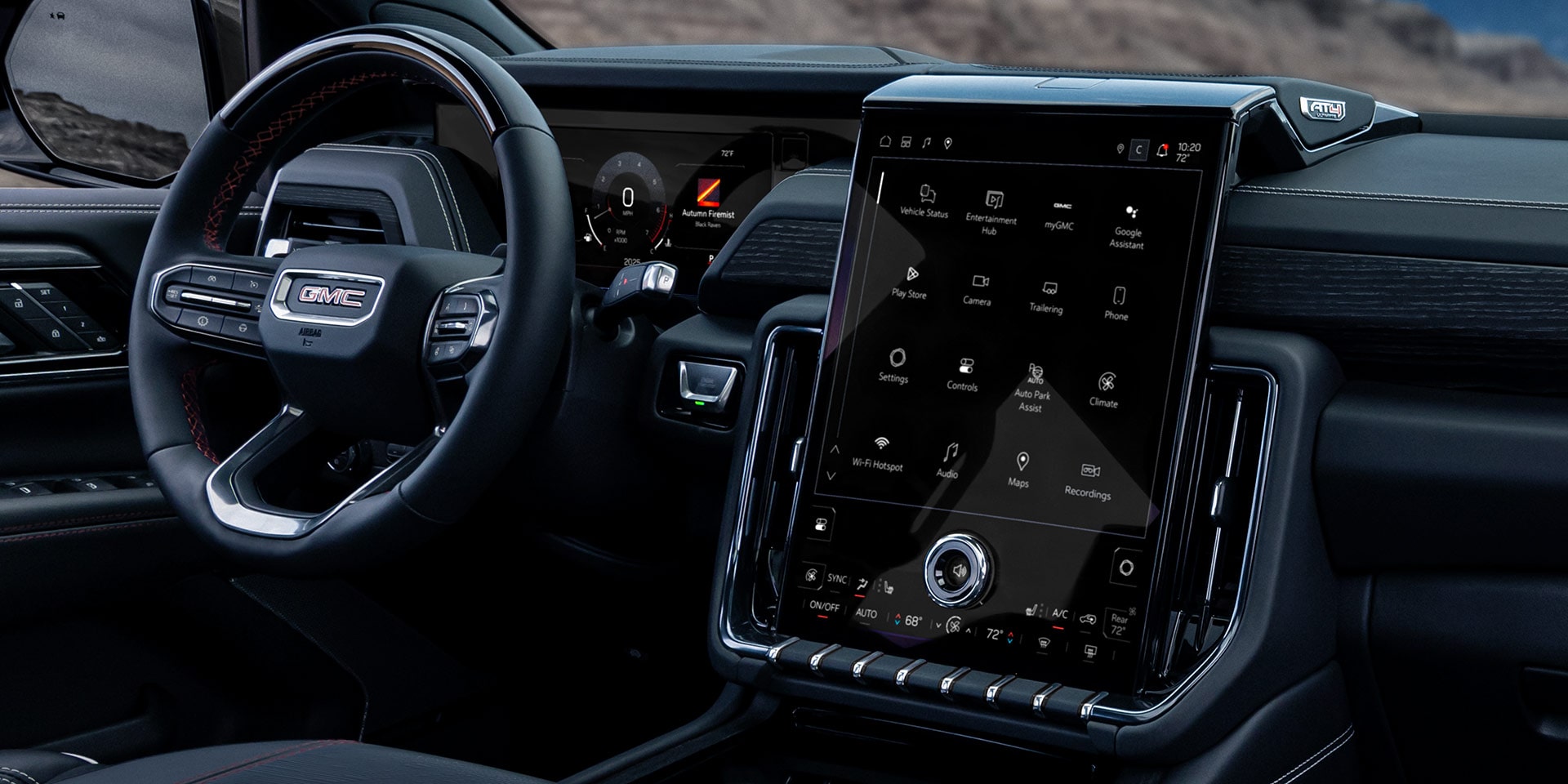 Front Interior Dashboard View of a GMC Yukon AT4 Ultimate with Dark Upholstery and a Large Infotainment Screen