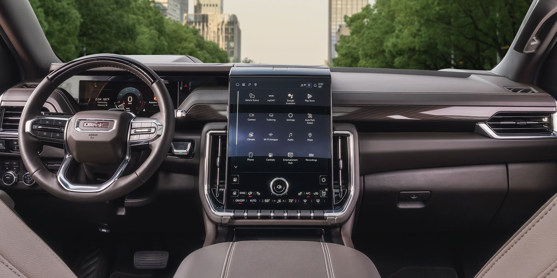 Interior Dashboard View of a GMC Yukon Elevation with a Large Infotainment Screen and City Street Visible Outside