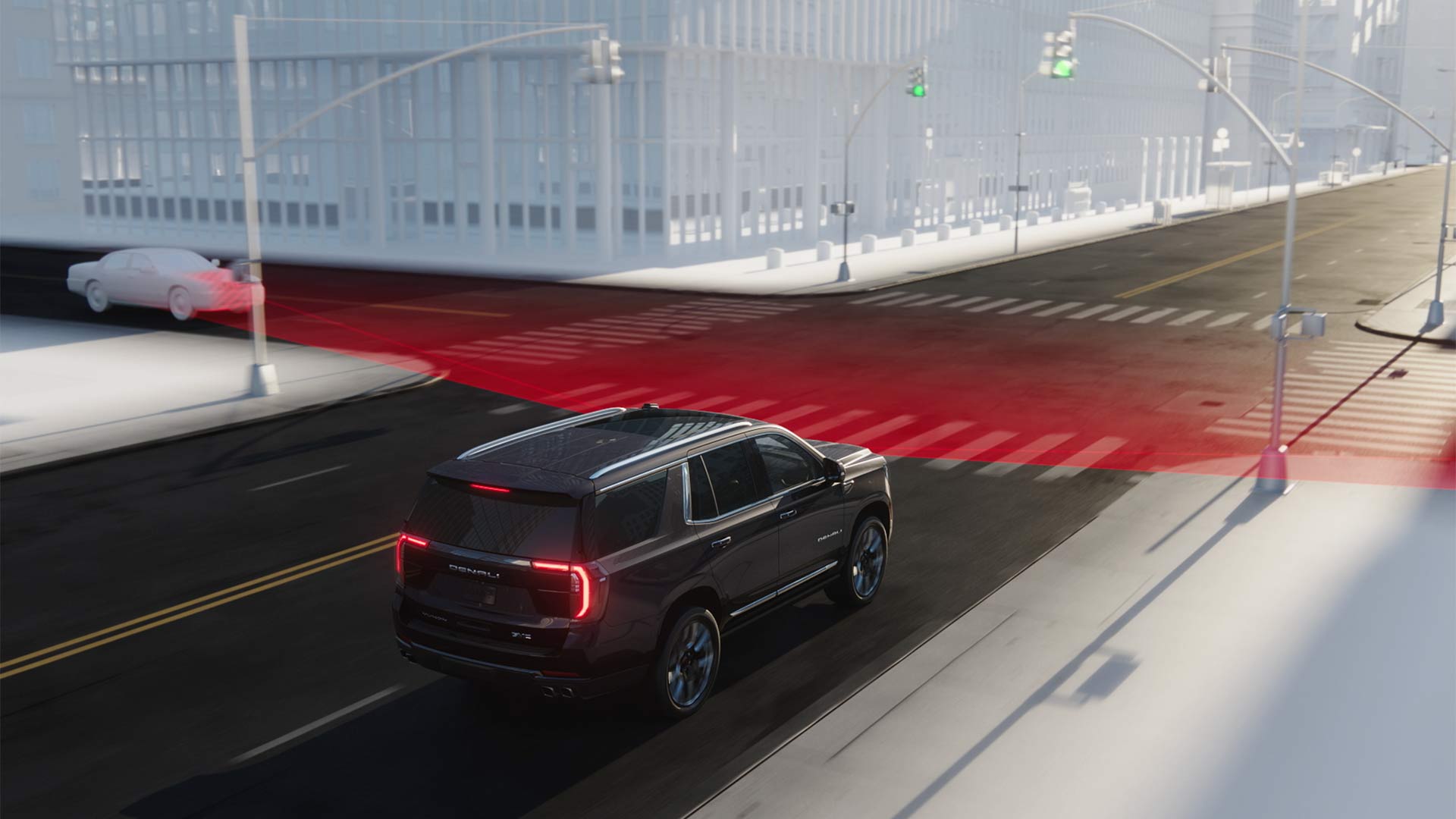 An Overhead View of a Dark GMC Yukon Turning at an Intersection with Red Lines Showing Intersection Automatic Emergency Braking