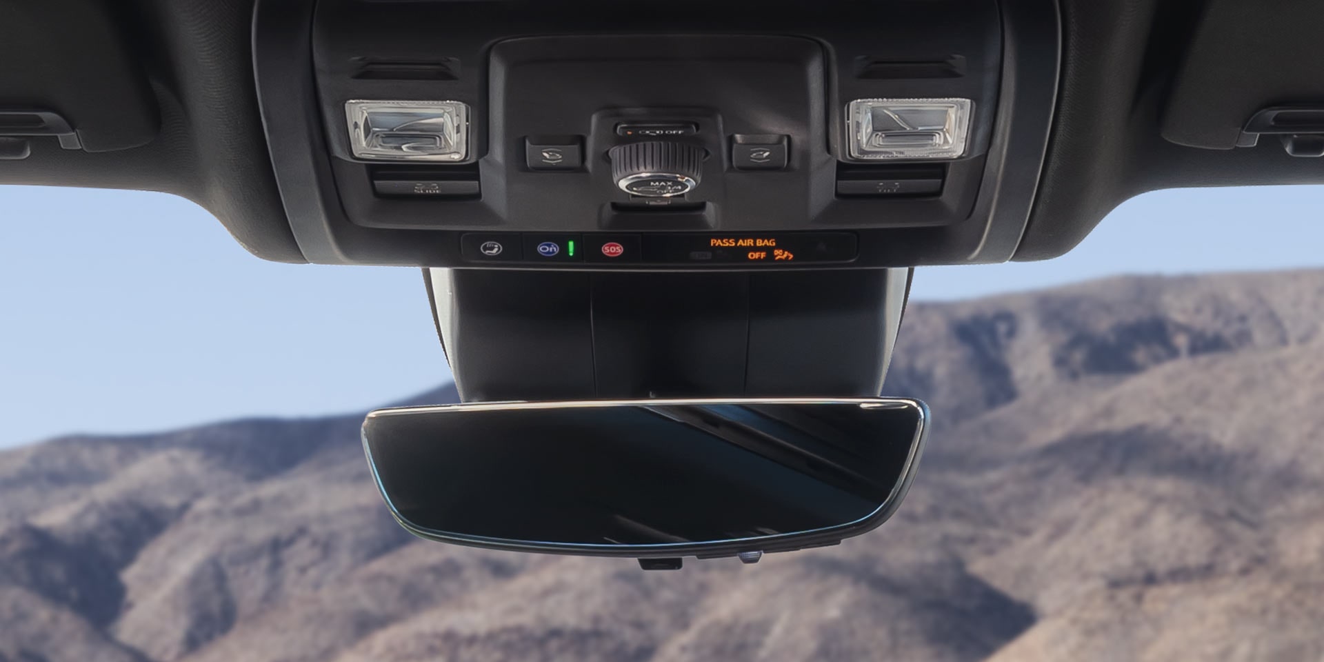 Overhead Console and Rearview Mirror in a GMC Yukon XL with Mountain Landscape Reflected