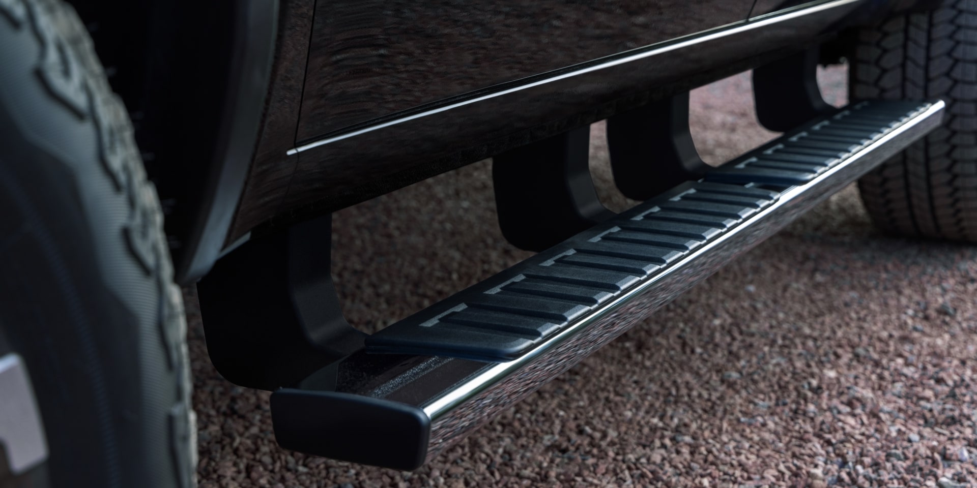 A Black Side Step Bar and the Denali Badge on the Side of a 2027 GMC Canyon Truck