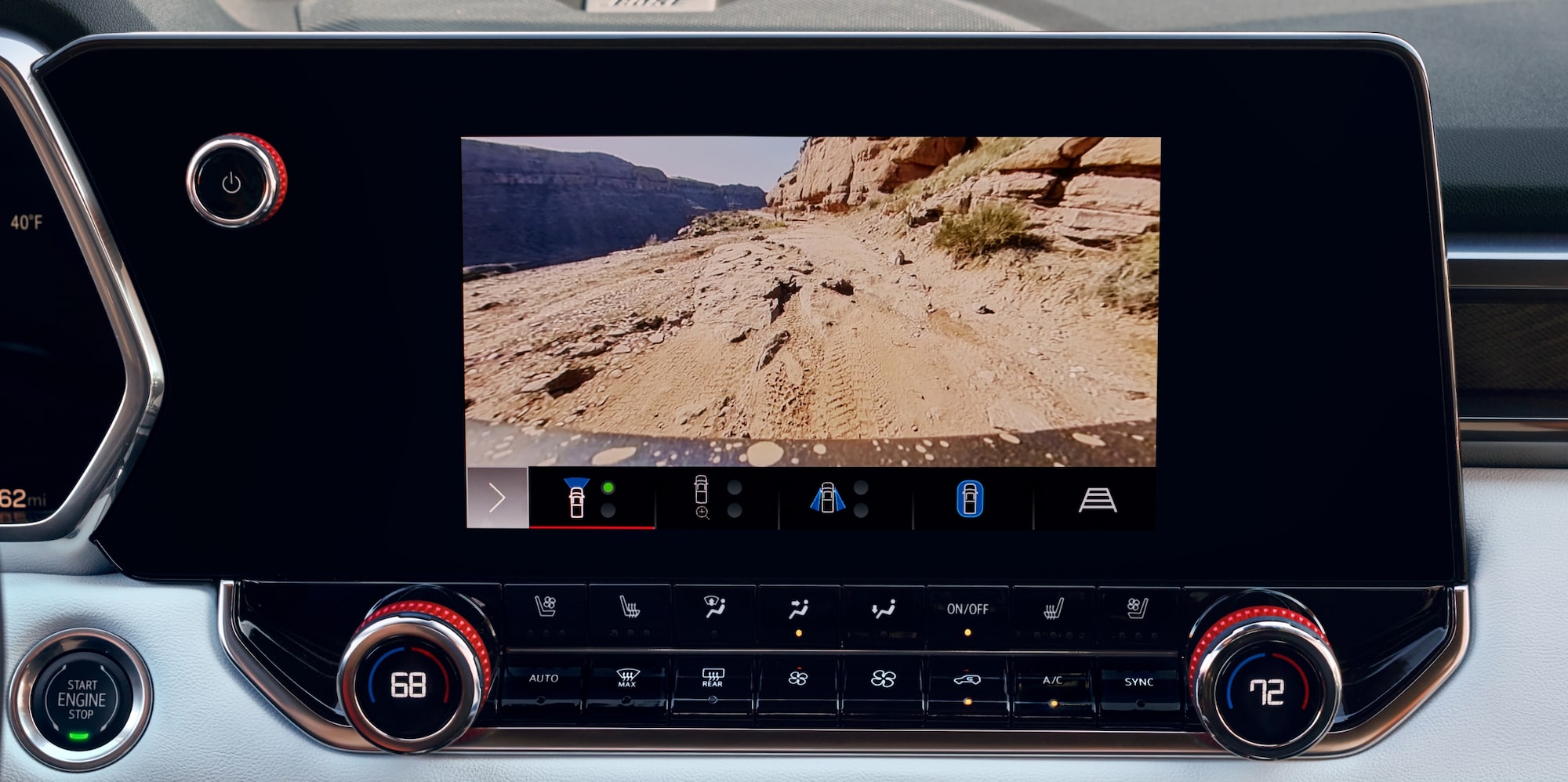 The Interior Dashboard of a 2027 GMC Canyon with an Infotainment Screen Displaying an Off-Road Trail View