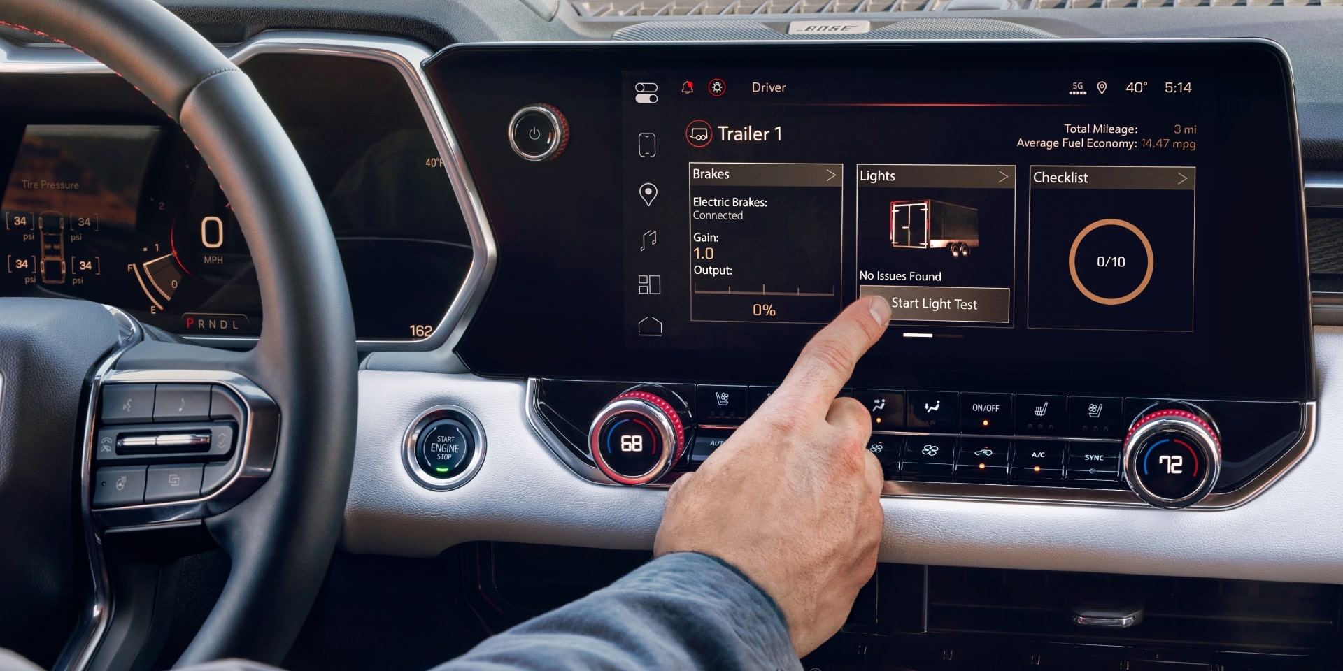 A Hand Touching the Large Infotainment Screen Inside the 2027 GMC Canyon Showing Navigation and Media Options