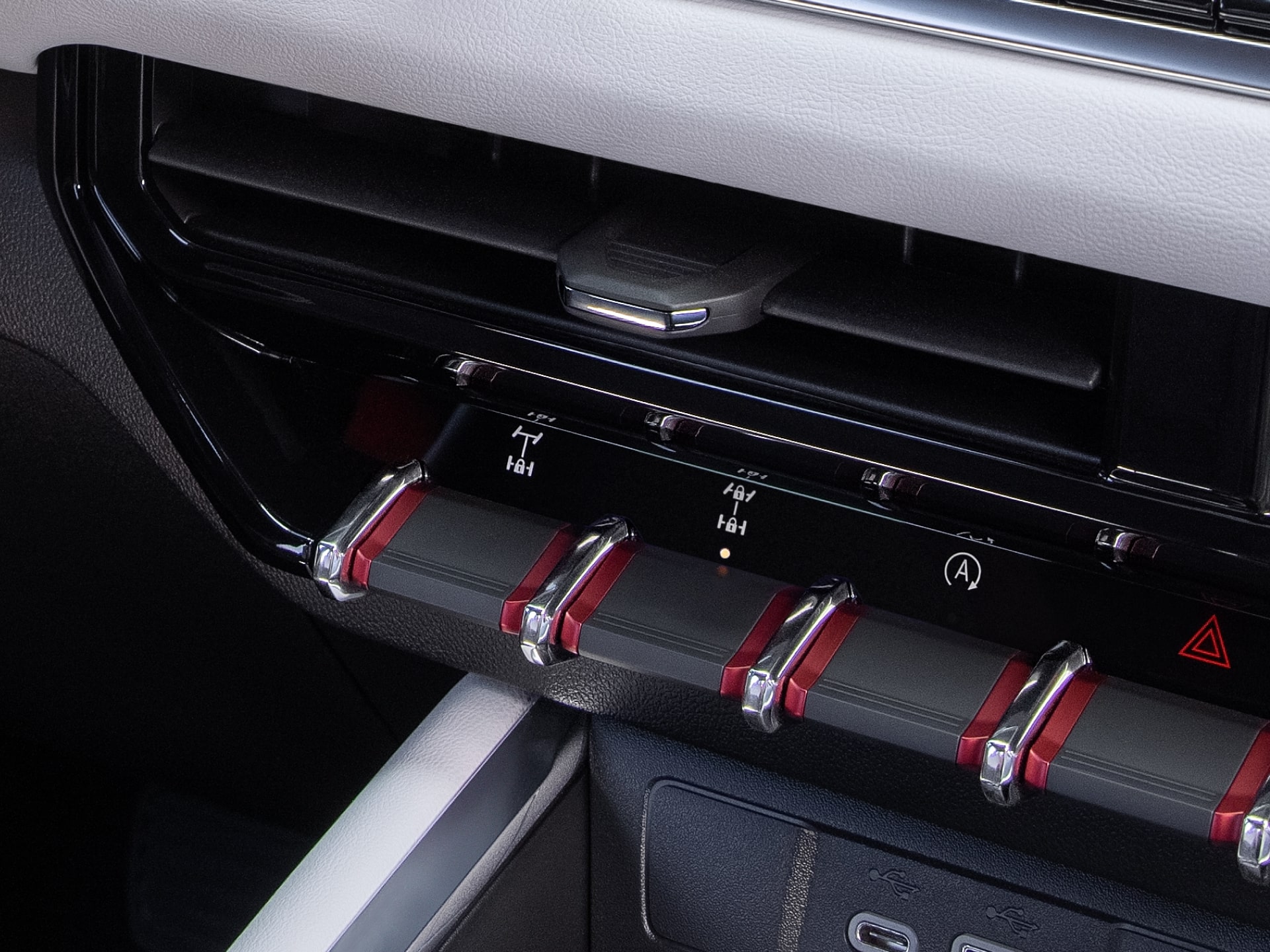 A Close-Up of the 2027 GMC Canyon Dashboard with Air Vents and Red-Accented Toggle Switches