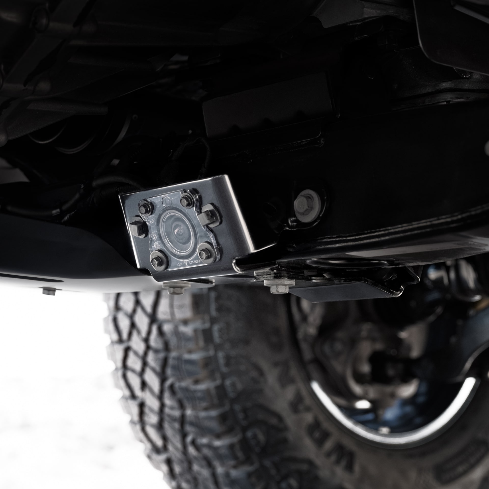 The Underside of a 2027 GMC Canyon Showing Off-Road Suspension Components and a Tire
