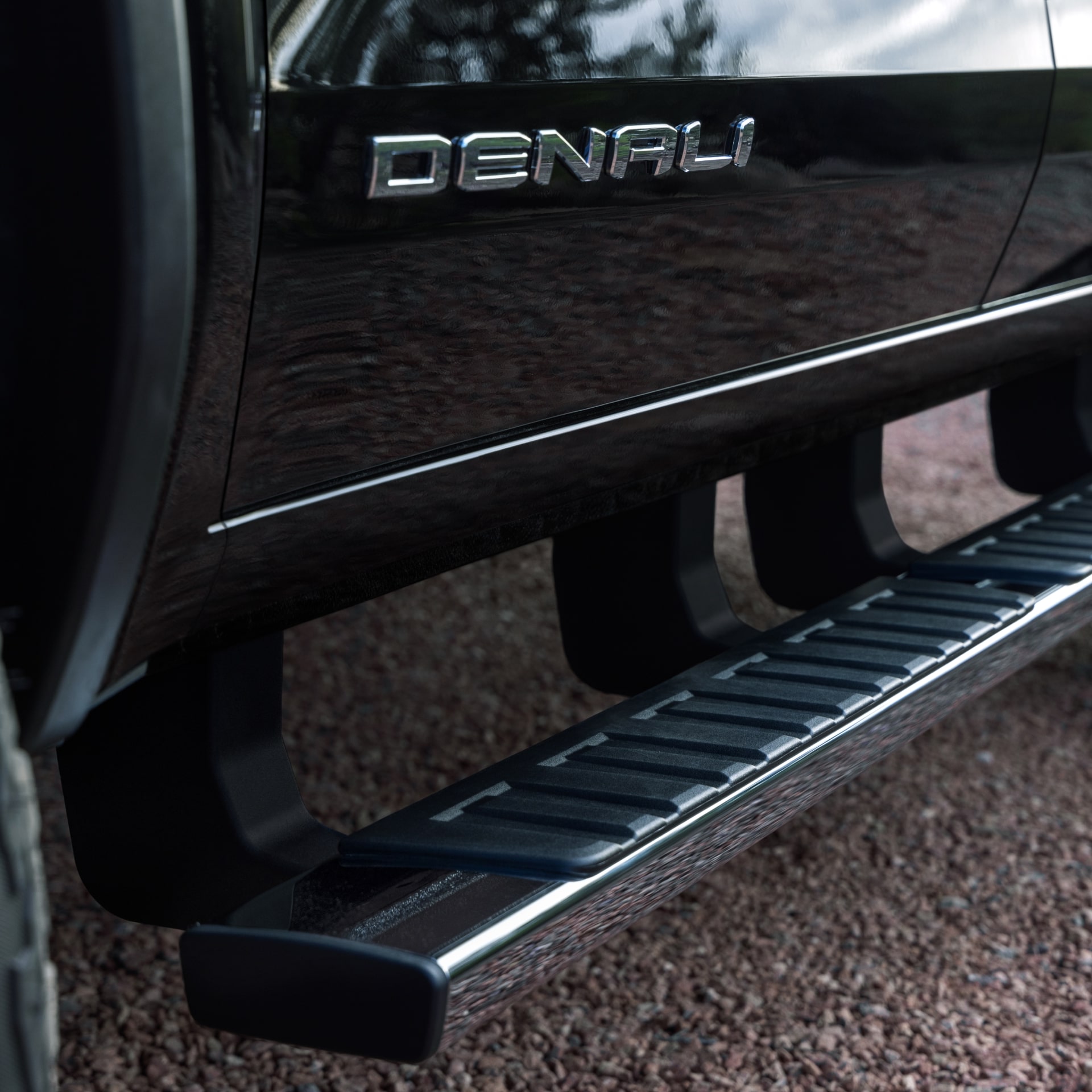 A Black Side Step Bar and the Denali Badge on the Side of a 2027 GMC Canyon Truck
