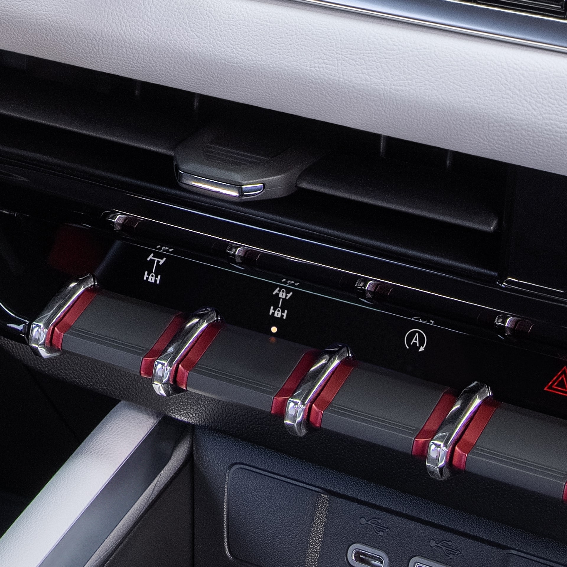 A Close-Up of the 2027 GMC Canyon Dashboard with Air Vents and Red-Accented Toggle Switches