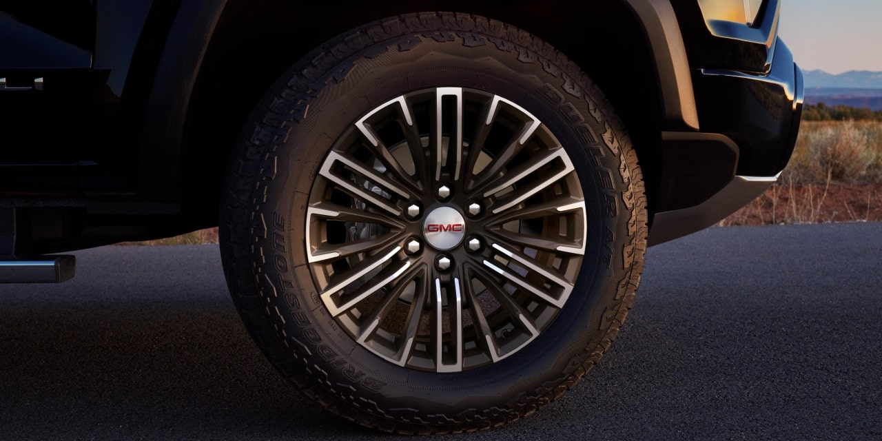 Close-Up Of a 2027 GMC Canyon AT4X Wheel With a Multi-Spoke Design and Red GMC Logo on the Hub