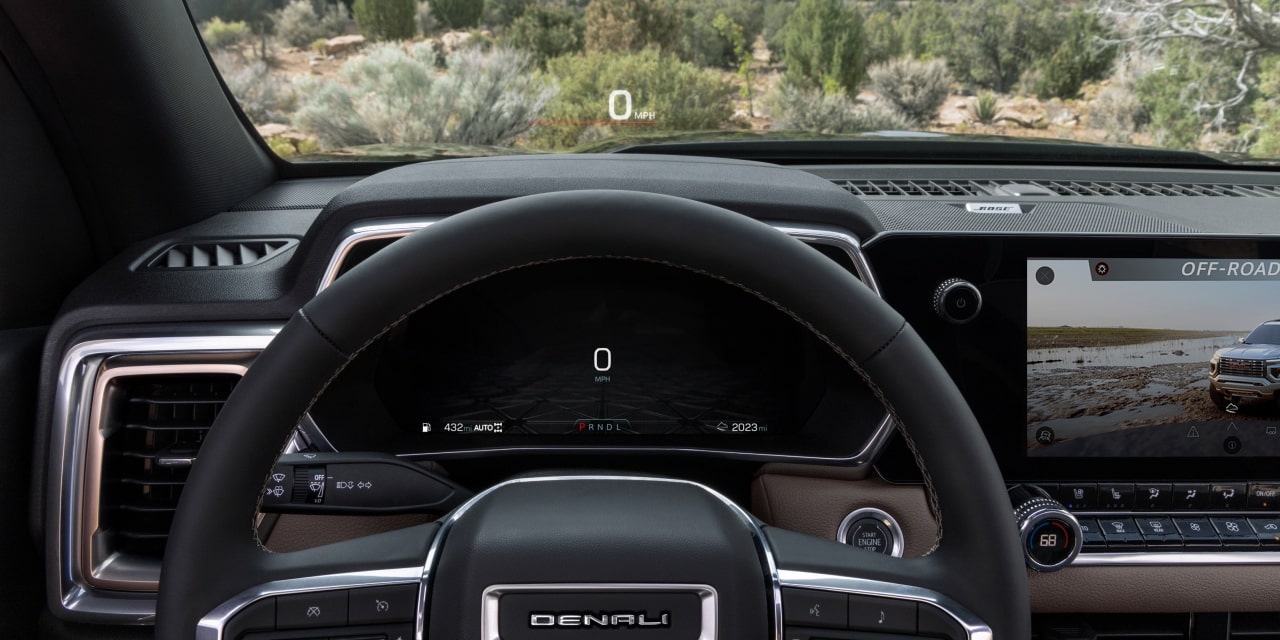 Driver's Perspective From Inside the 2027 GMC Canyon Showing a Heads-Up Display With "34 MPH" on a Dirt Road