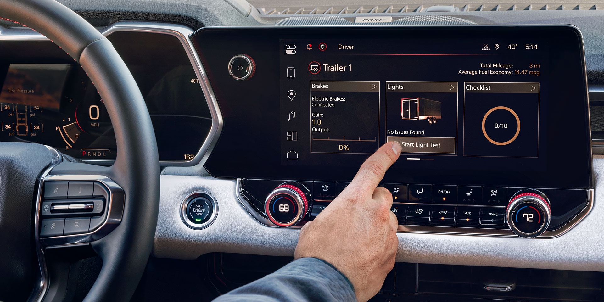 A Hand Touching the Large Infotainment Screen Inside the 2027 GMC Canyon Showing Navigation and Media Options