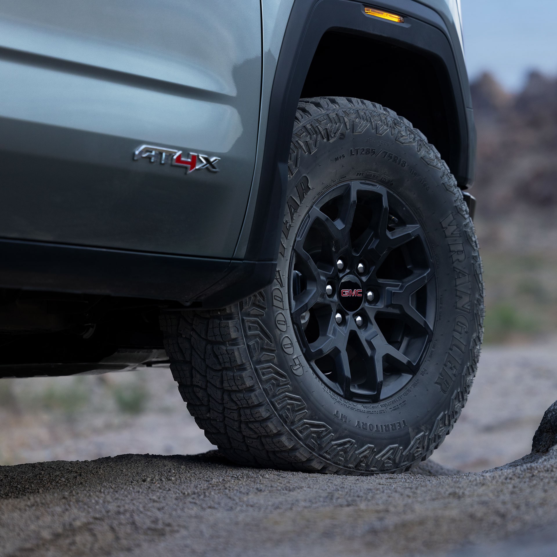 A Close Up of the Black Wheel and All Terrain Tire on the GMC Sierra AT4X Truck