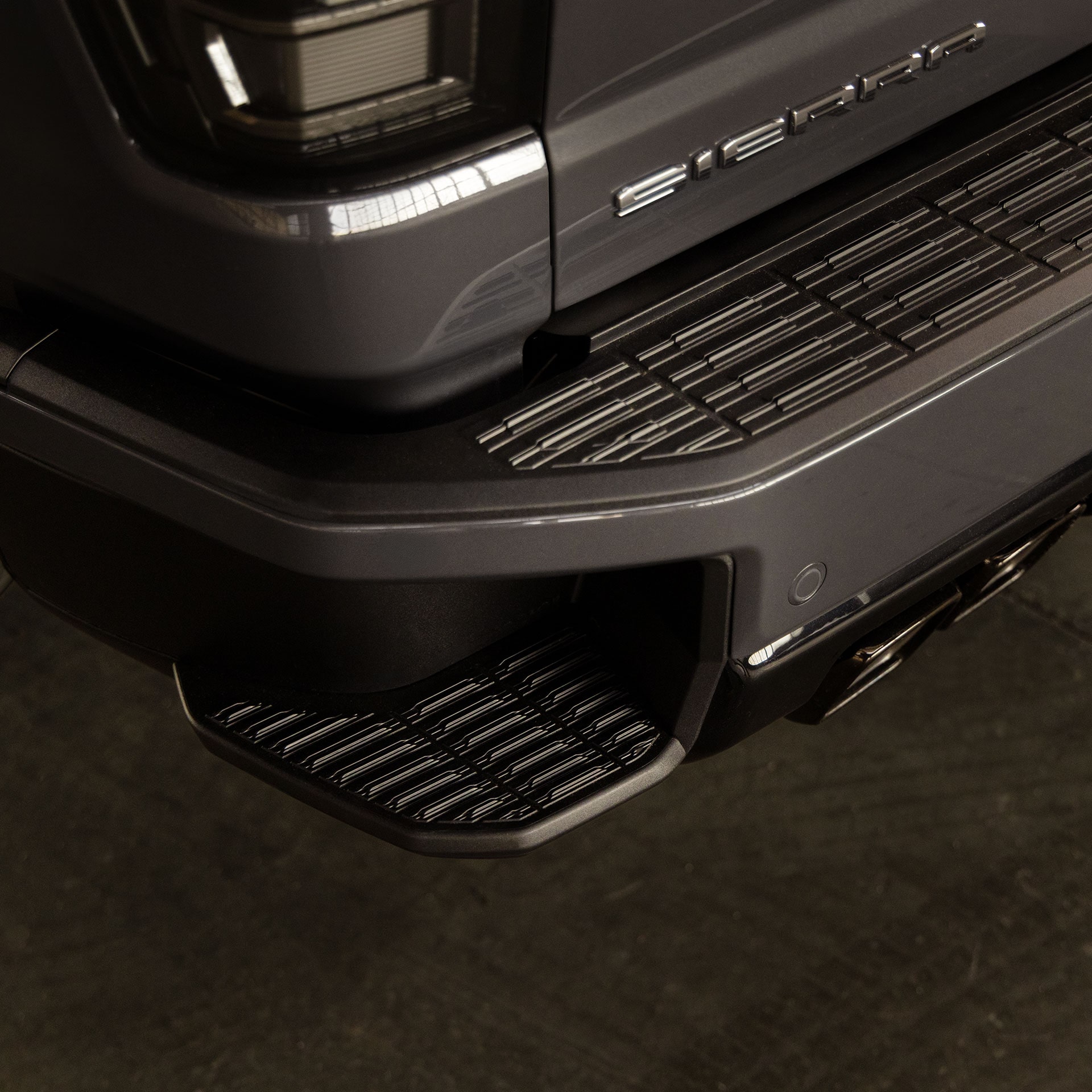 A Close Up of the Rear Bumper and Integrated Side Step on the GMC Sierra 1500 Truck