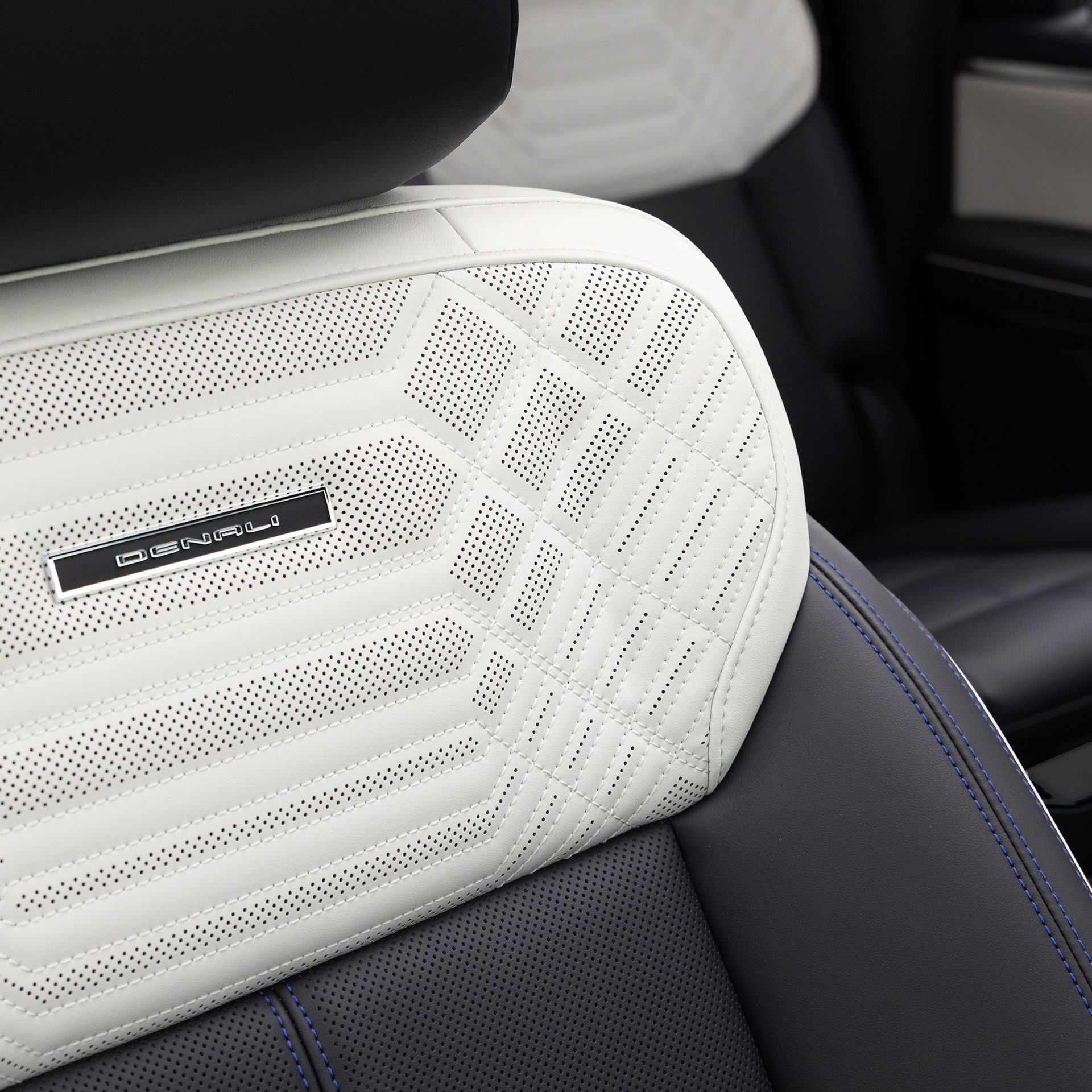 A Close-up View of the GMC Sierra 1500 Denali White Leather Seat Headrest with Geometric Stitching