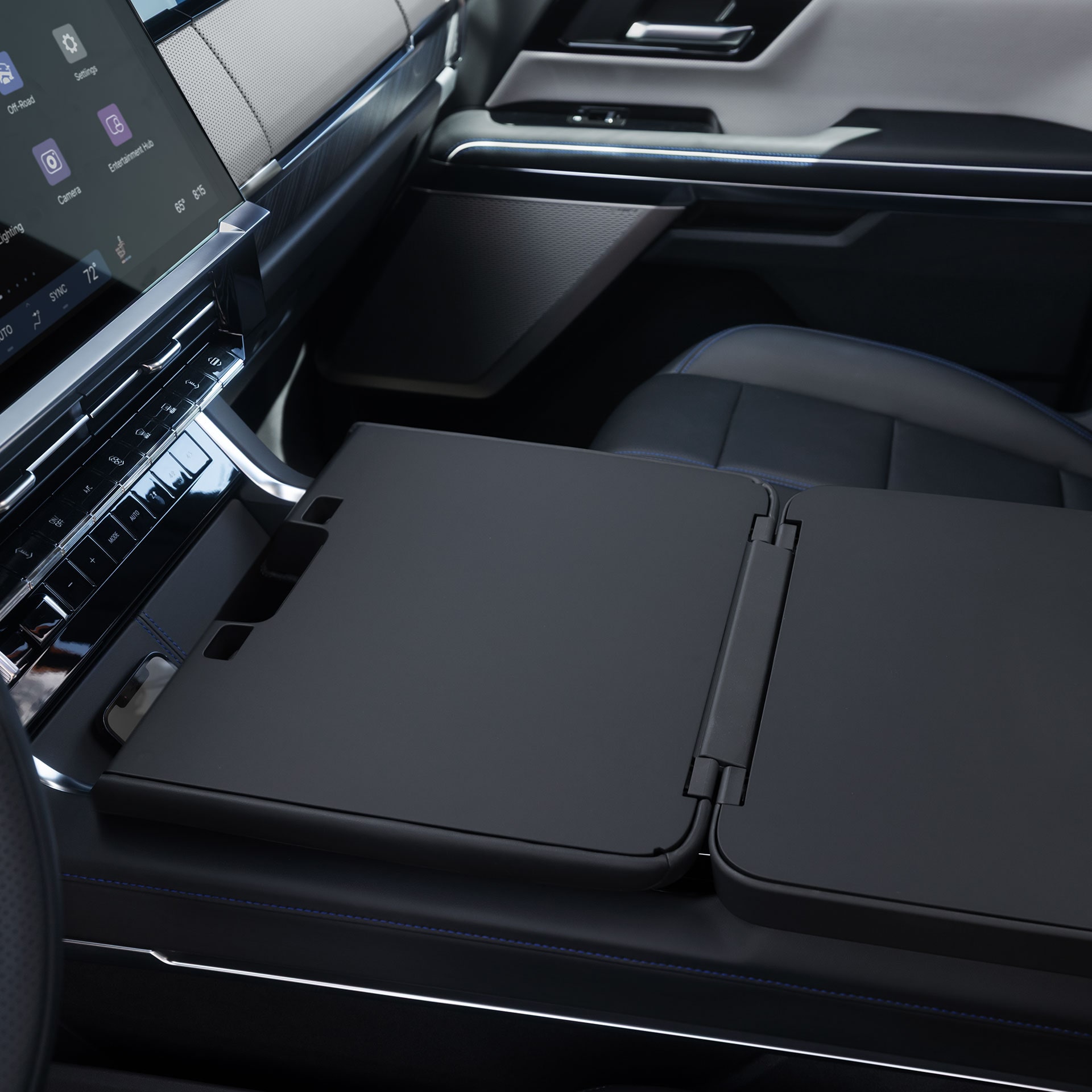 The Foldable Flat Work Surface Extended From the Center Console in the GMC Sierra 1500