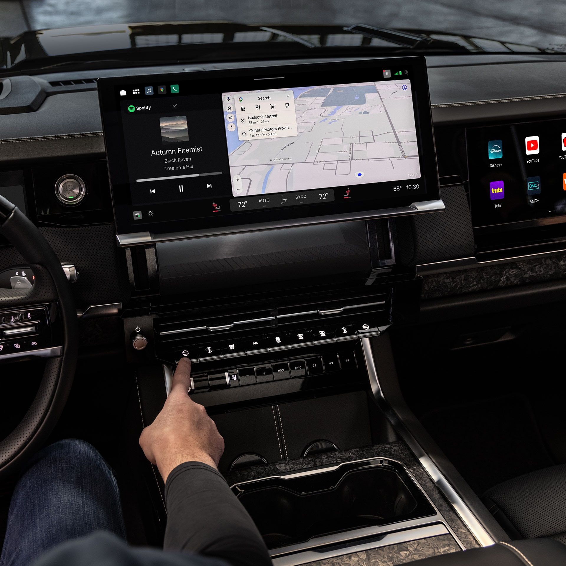 A Driver's Hand Interacting With the Large Digital Infotainment Screen in the GMC Sierra 1500 Interior
